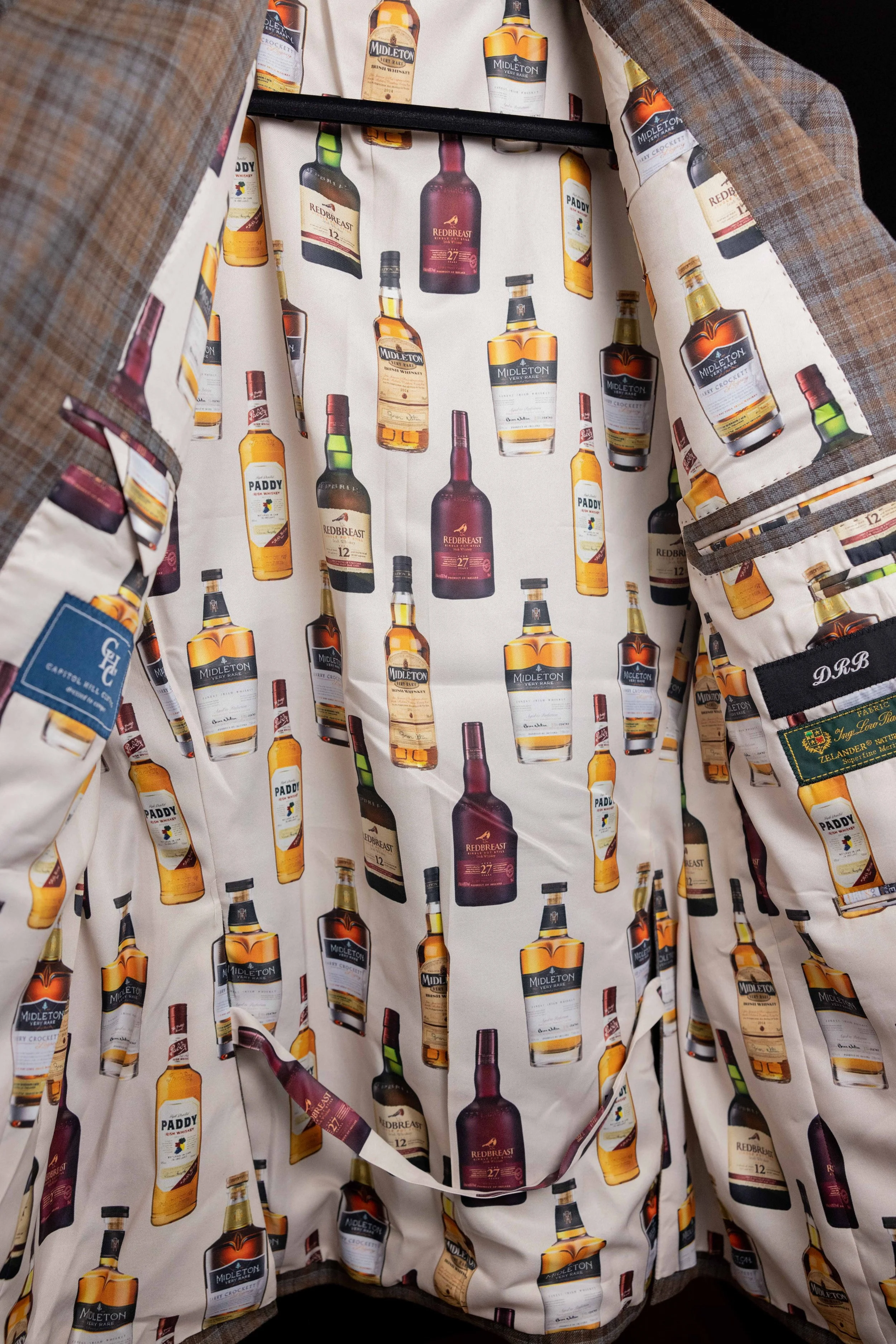 Plaid jacket with whiskey bottle print lining. Fabrics for custom suits in Washington, DC