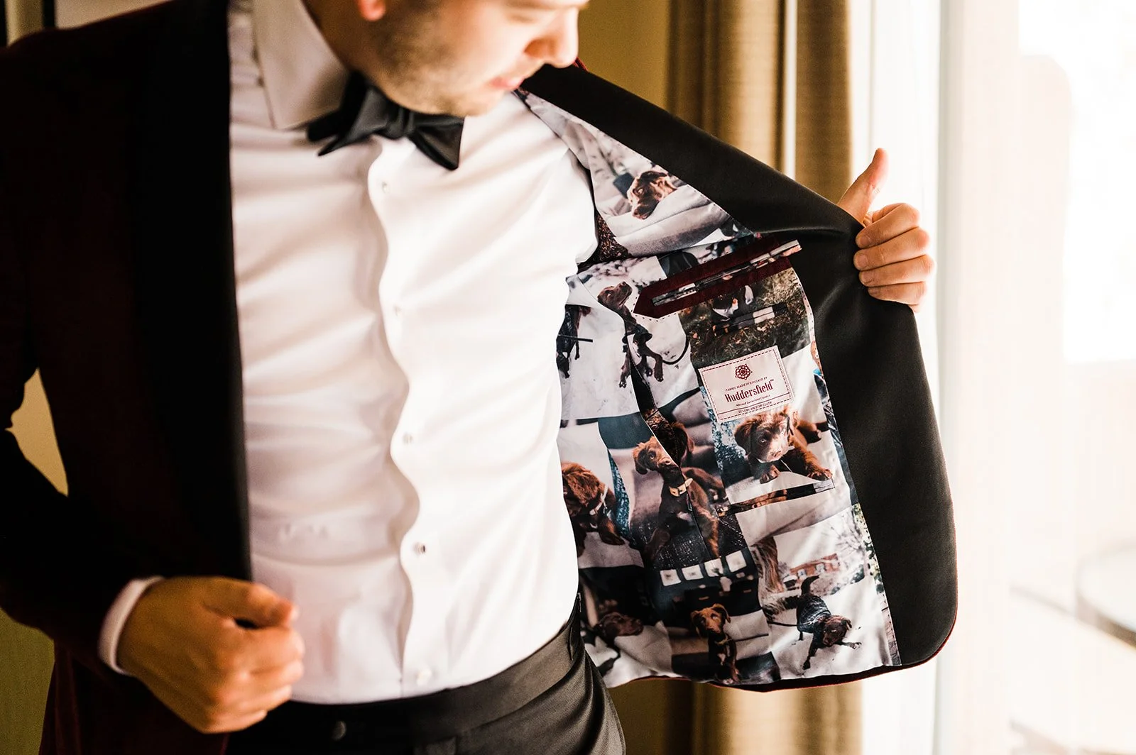 Person wearing a suit jacket with a custom lining featuring photos of a dog. Fabrics for custom tuxedo in Washington, DC