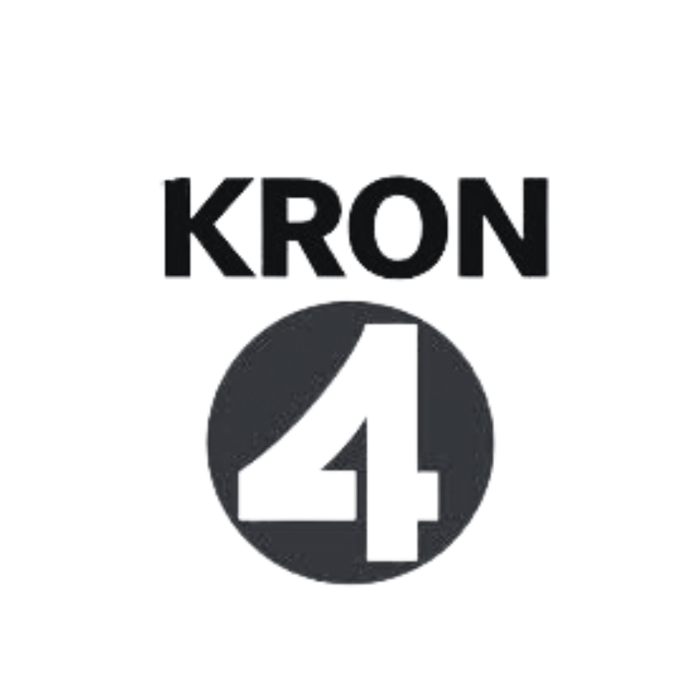 Black and white logo with the text 'Kron 4' above a black circle containing a large number 4.