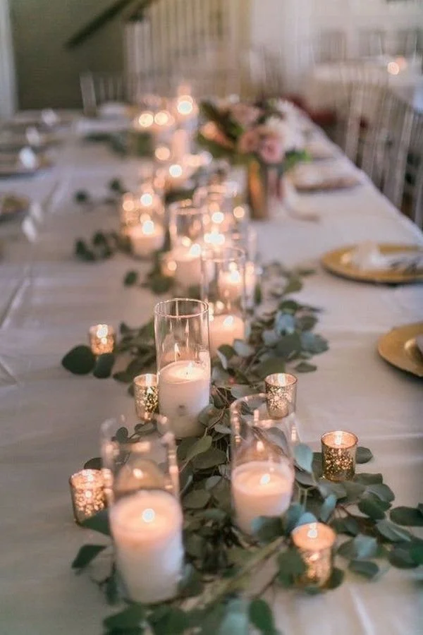 ntimate Cleveland winter wedding table with greenery, candles, and warm lighting