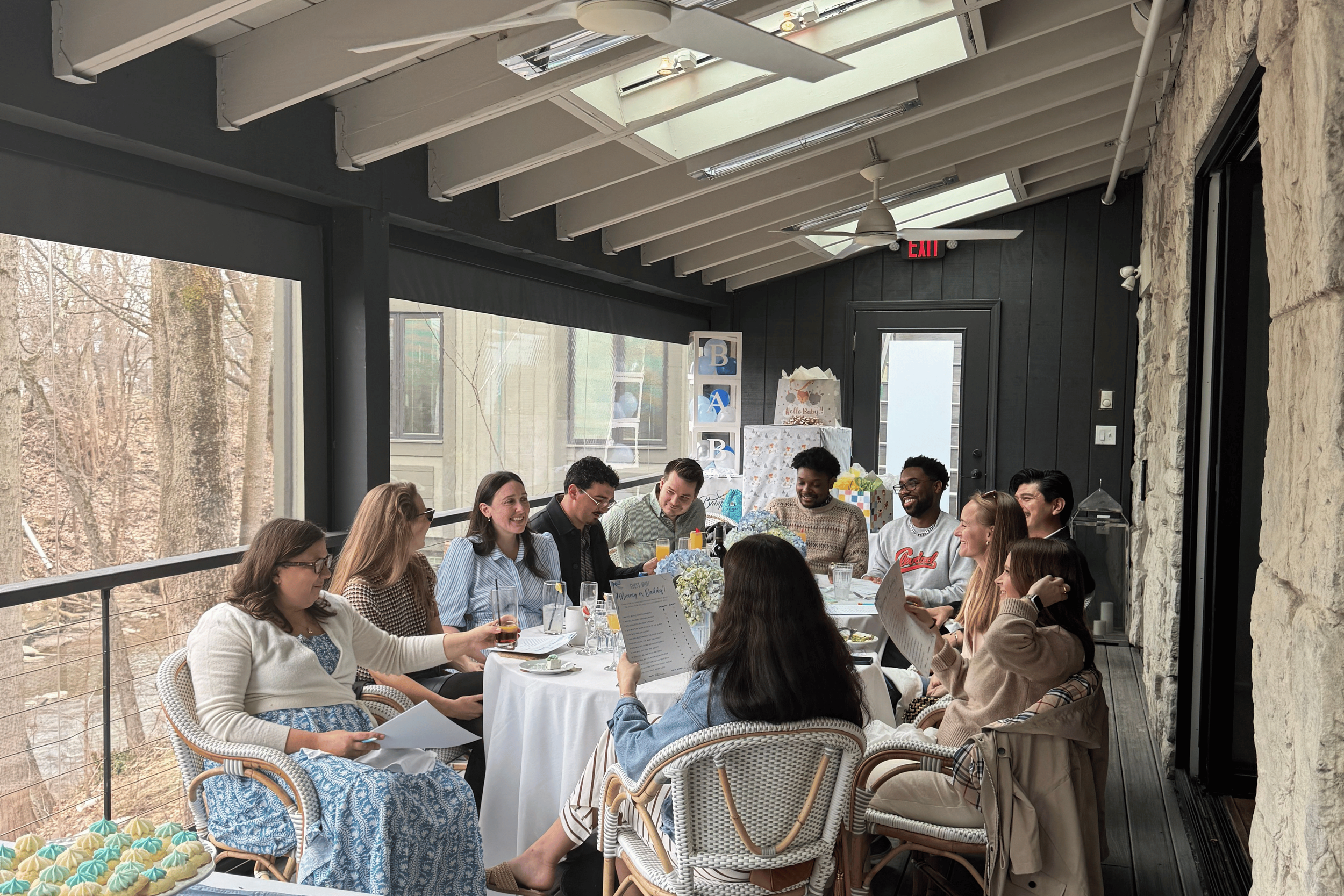 Relaxed host laughing with guests during a home celebration