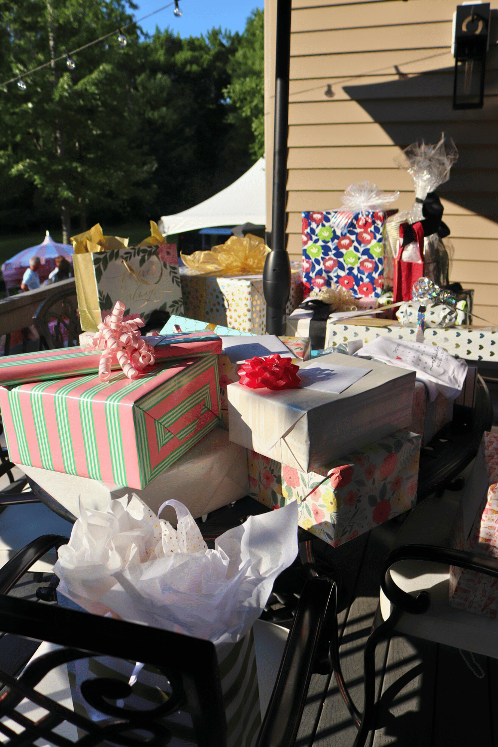 Bridal shower gifts displayed on table at outdoor celebration
