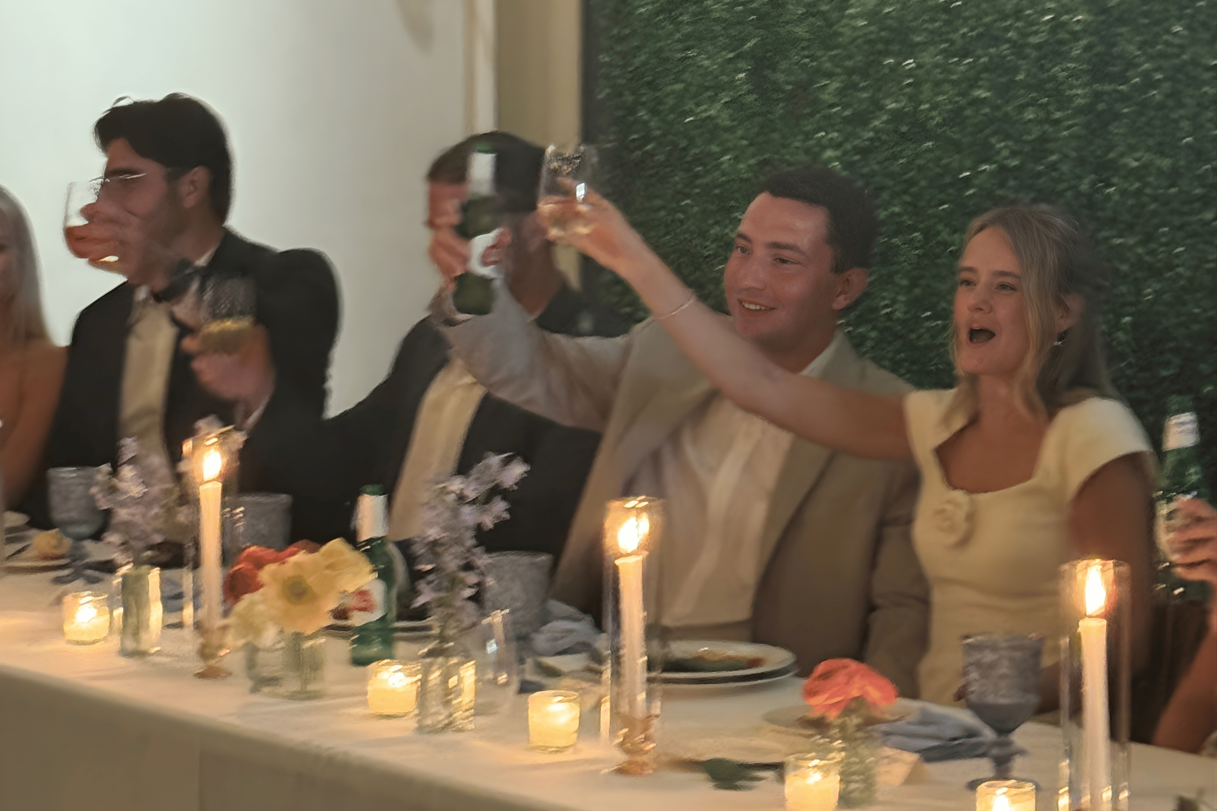 Quiet candlelit toast during an intimate celebration