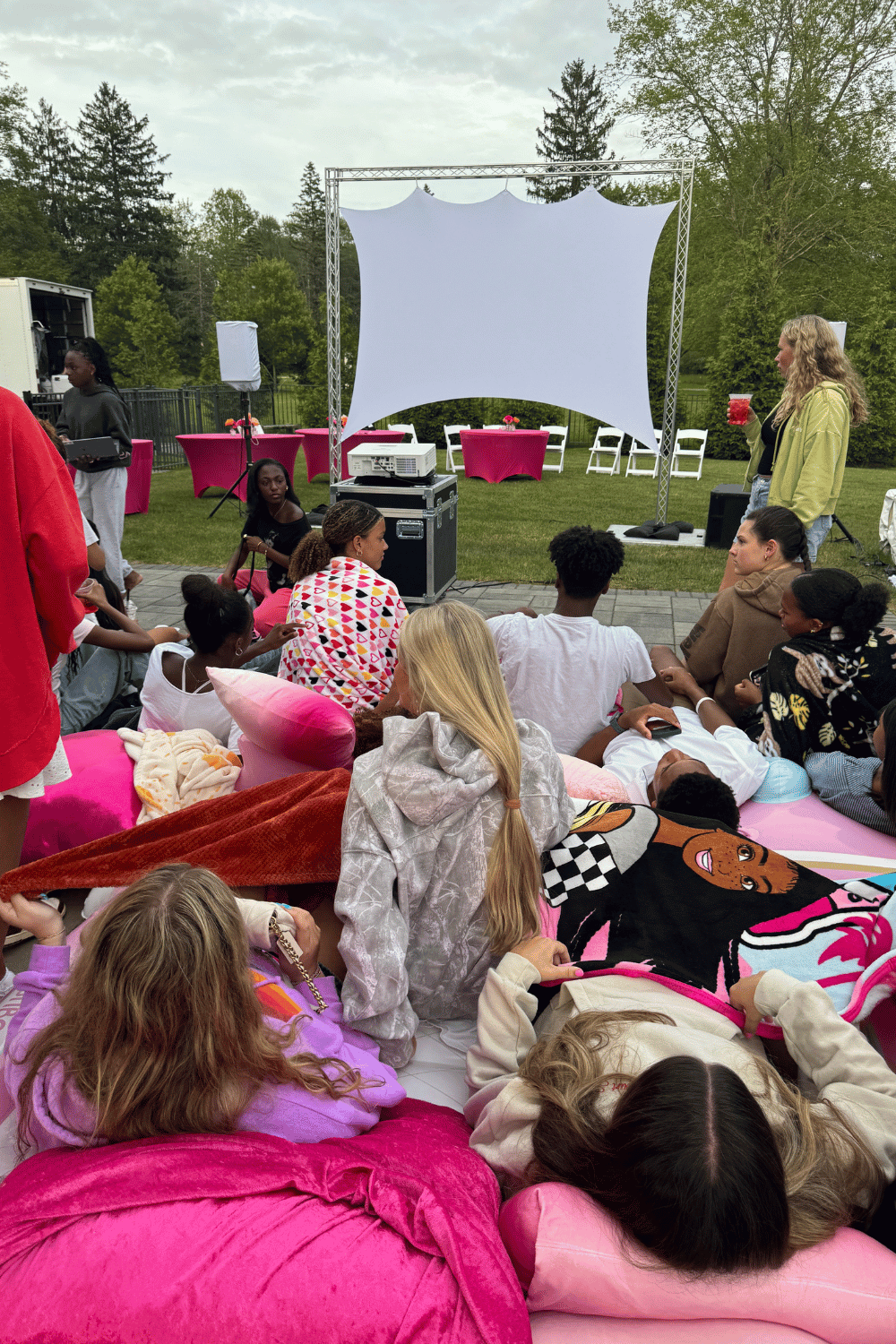 Friends enjoying a relaxed backyard gathering with drinks and snacks