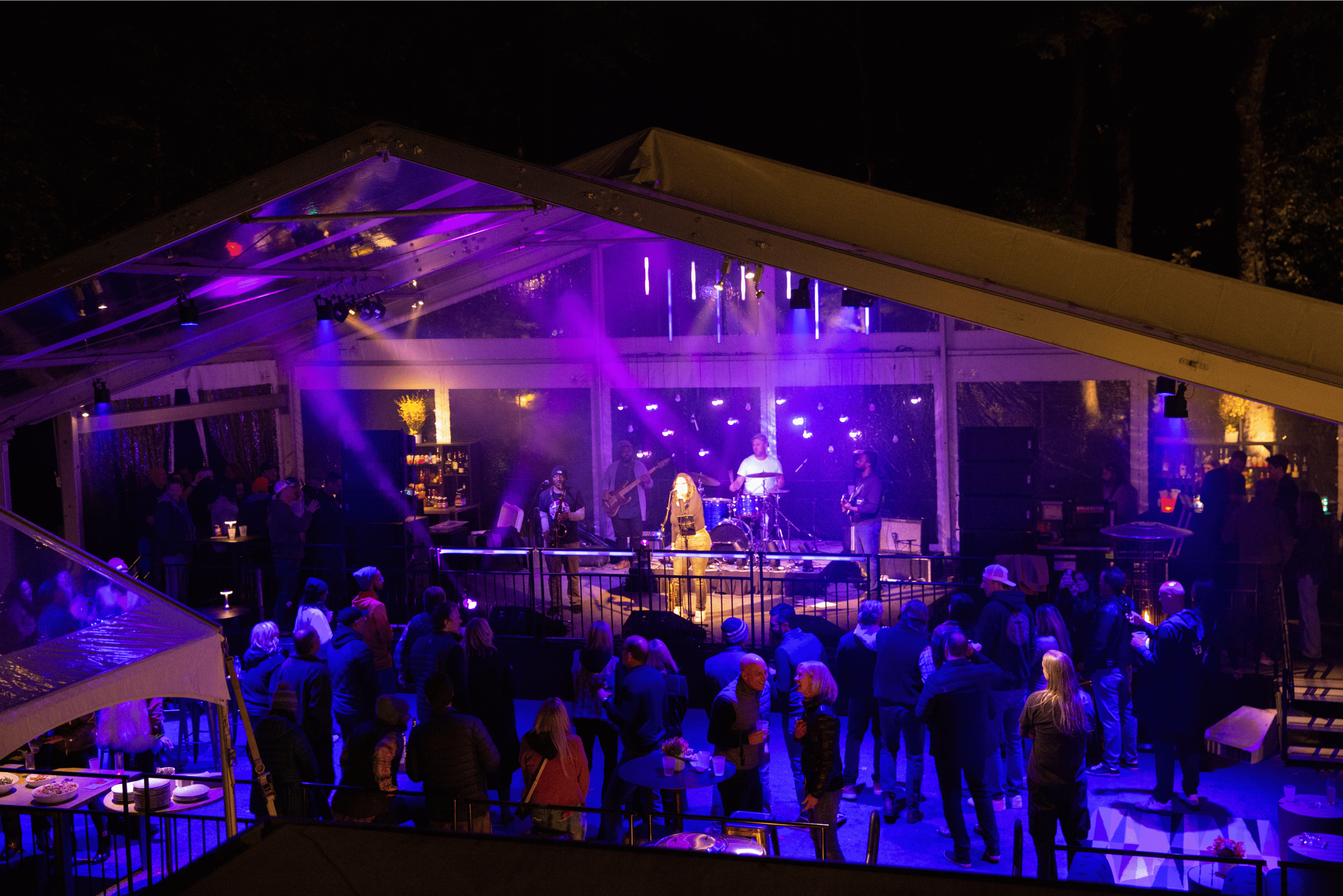 Guests enjoying a warm, intimate home celebration with soft lighting