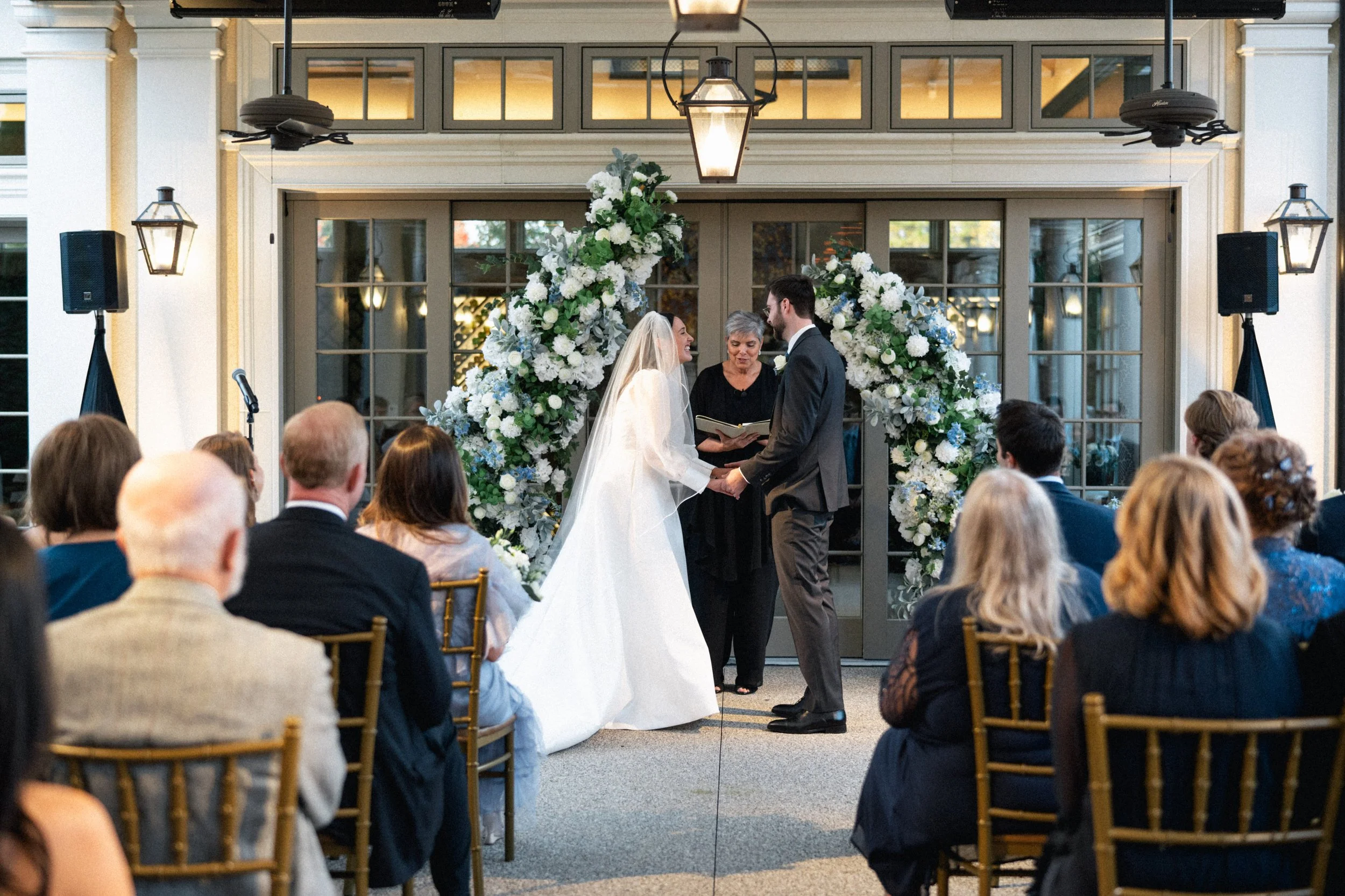 Courtney and Reed exchanging vows during their outdoor garden ceremony at Cru Uncorked.