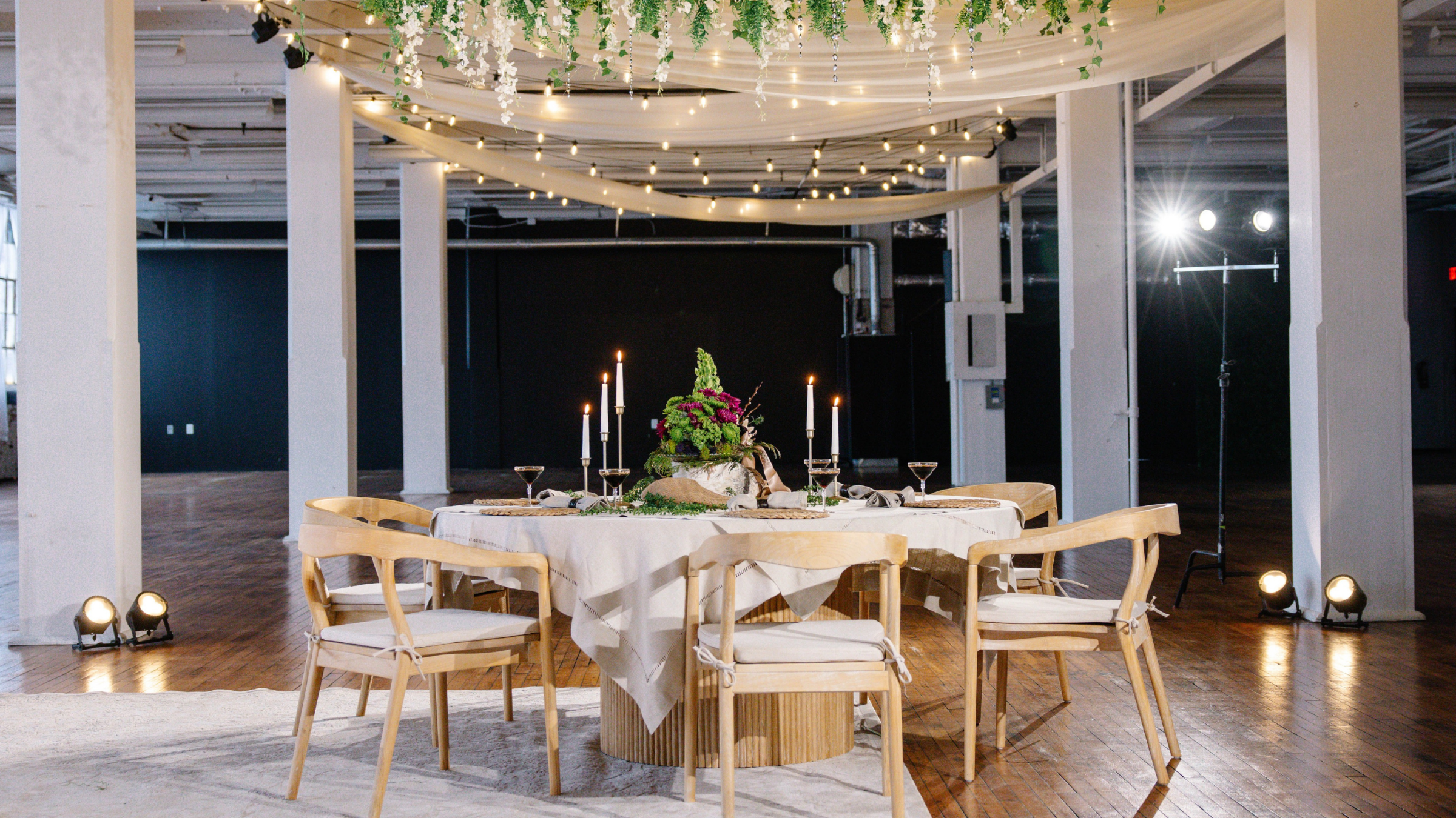 Folklore era cozy woodland wedding Cleveland - farm tables, warm lighting, fall florals by Sterling Event Services