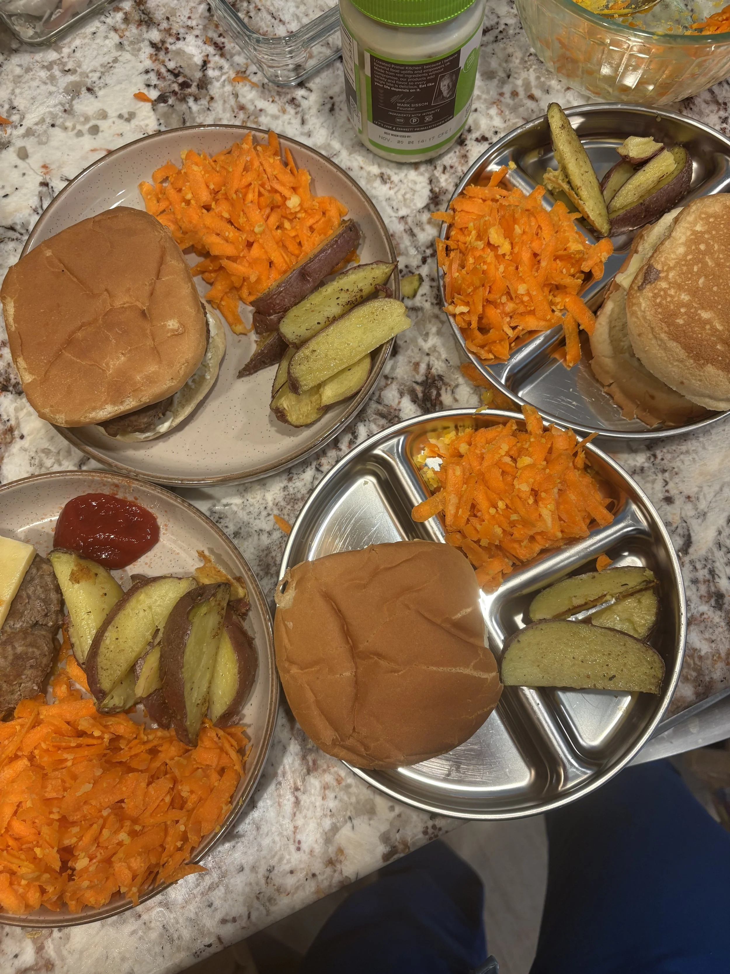 Burgers, carrot salad, and roasted potatoes