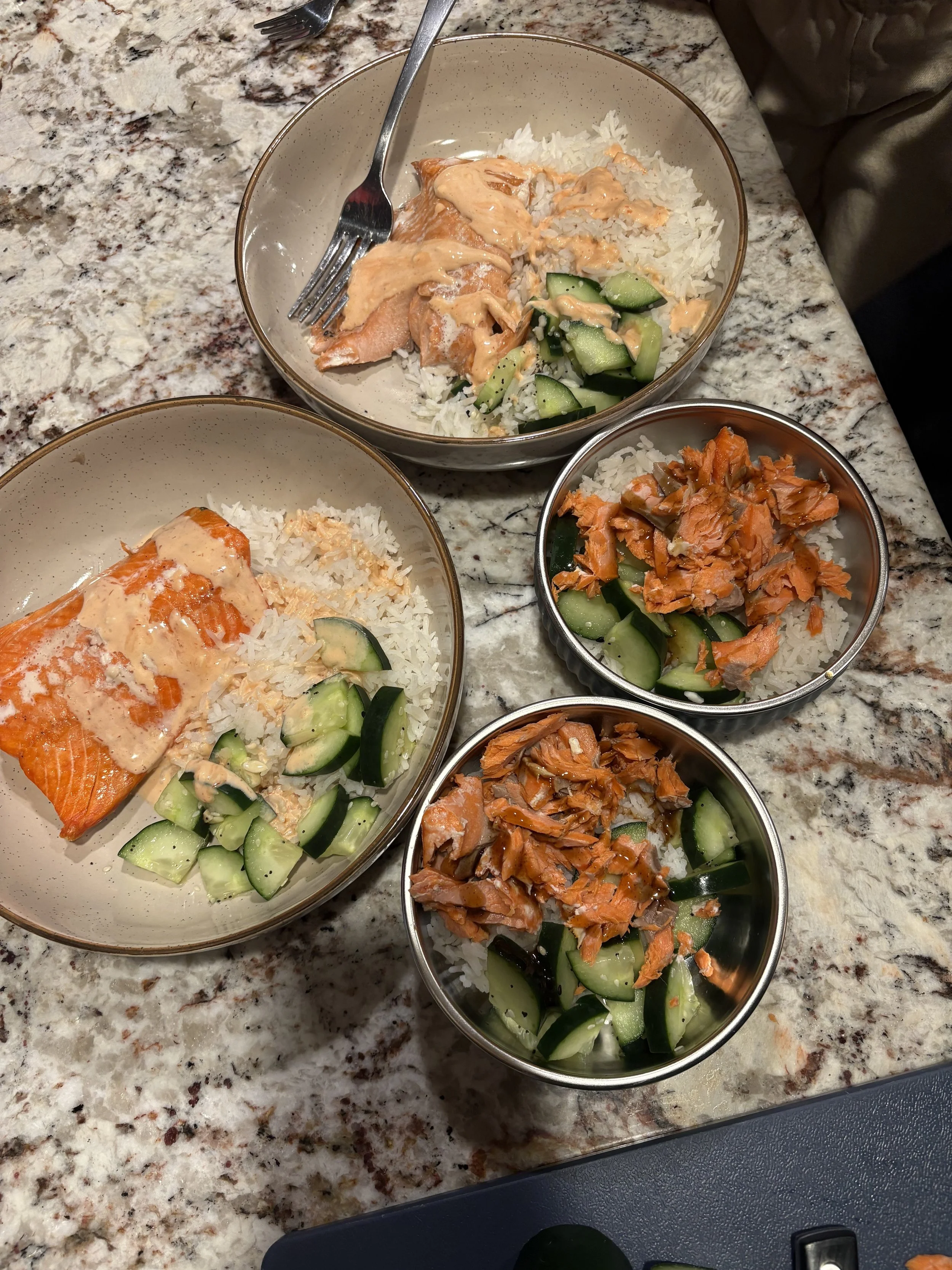 salmon bowls with rice, cucumbers, and sriracha mayo