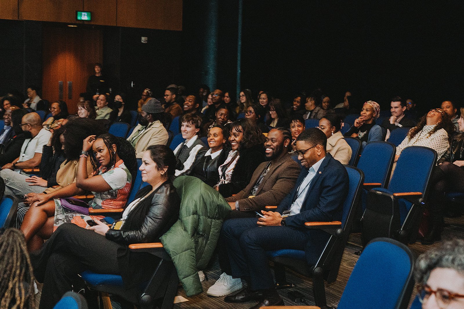 Audience in theatre smiling.jpg