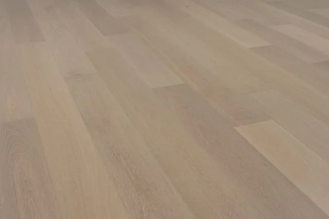 Close-up of a light-colored wooden floor with a smooth finish.