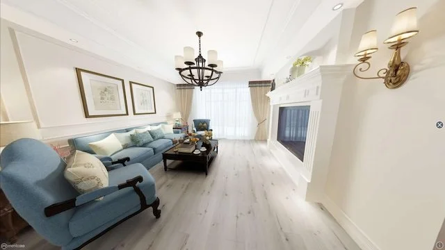 Bright living room with white walls, a light blue sofa, matching armchair, dark wood coffee table, chandelier, wall-mounted lamps, fireplace, and large window with curtains.