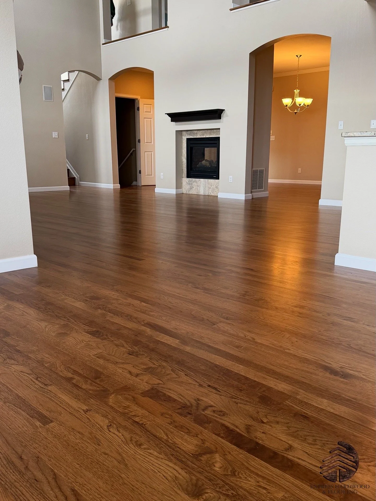 Refinished hickory hardwood floor after sanding and color change to Provincial stain, showcasing rich warm brown tones and smooth professional finish by Express Hardwood & Flooring.