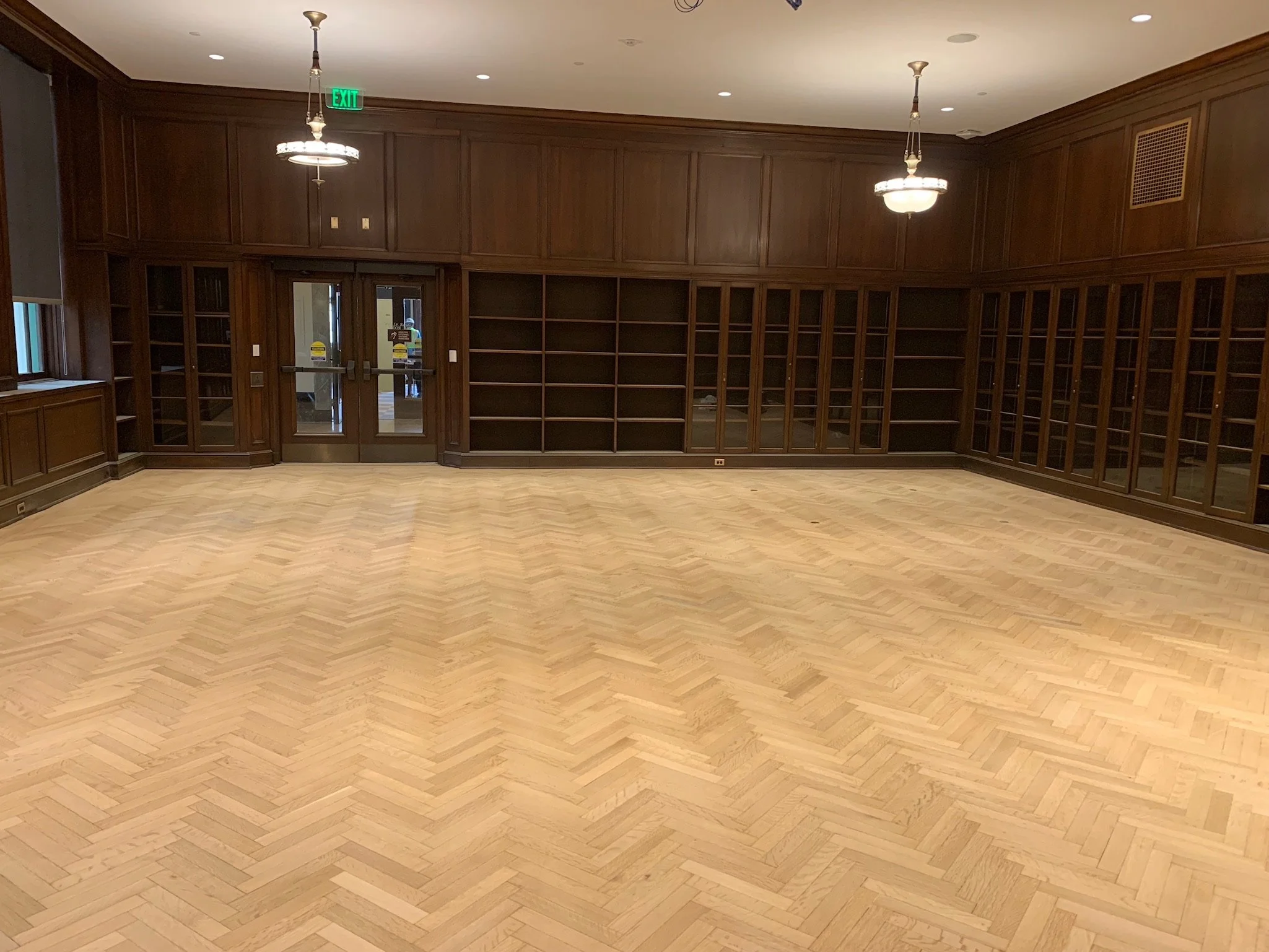 Chevron pattern hardwood floor newly installed, showing raw wood surface prior to sanding, staining, and finishing by Express Hardwood & Flooring.