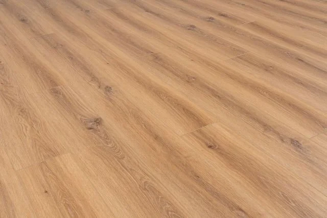 Close-up of a wooden laminate floor with a light oak finish.