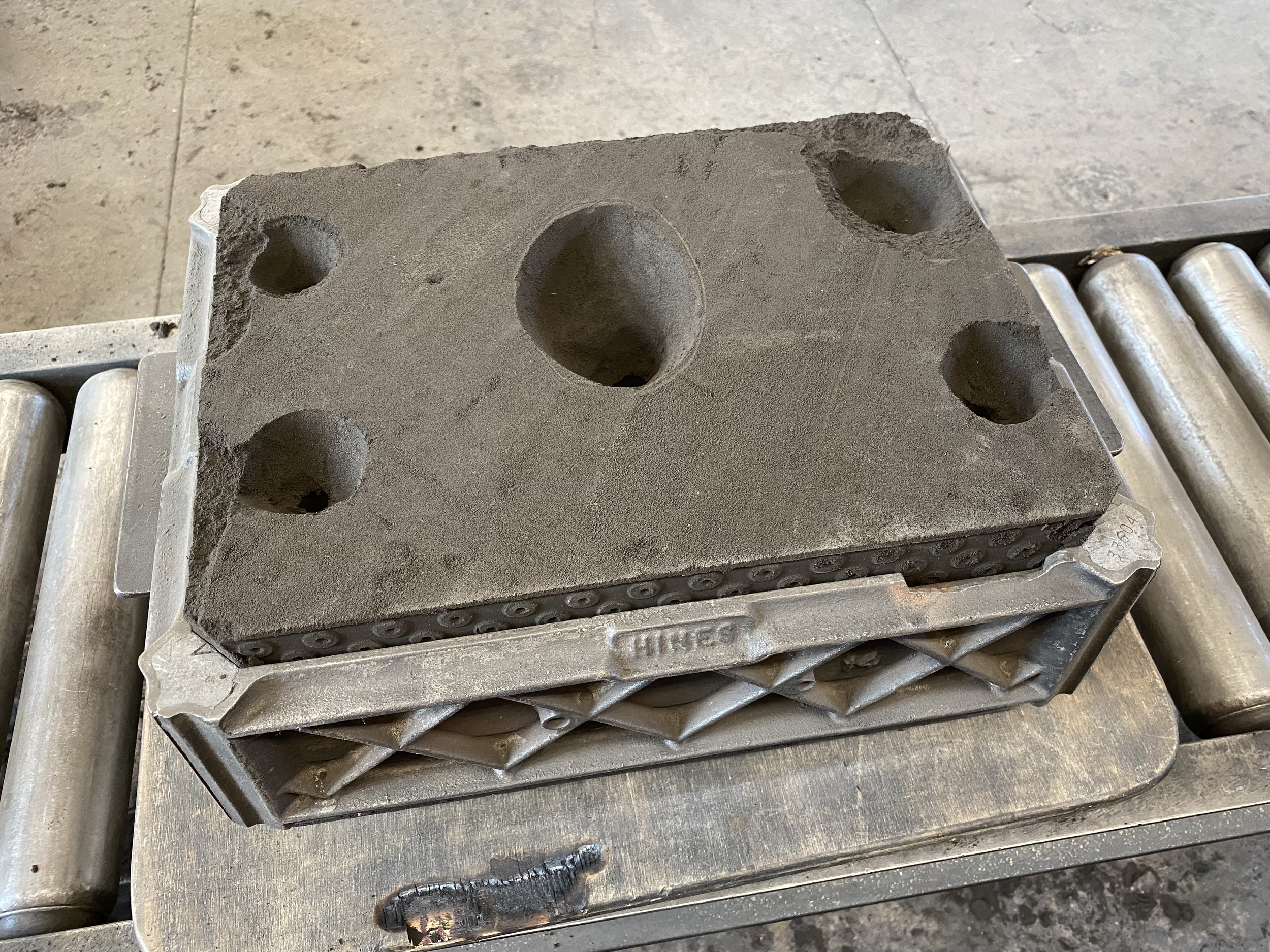 sand cast mold with fire jacket around it to prevent molten metal leaks