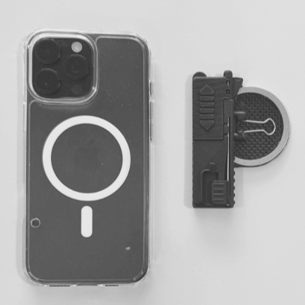 An iPhone lies adjacent to the Case for Vision Ergo, a small innovative stand to enable hands-free magnification.