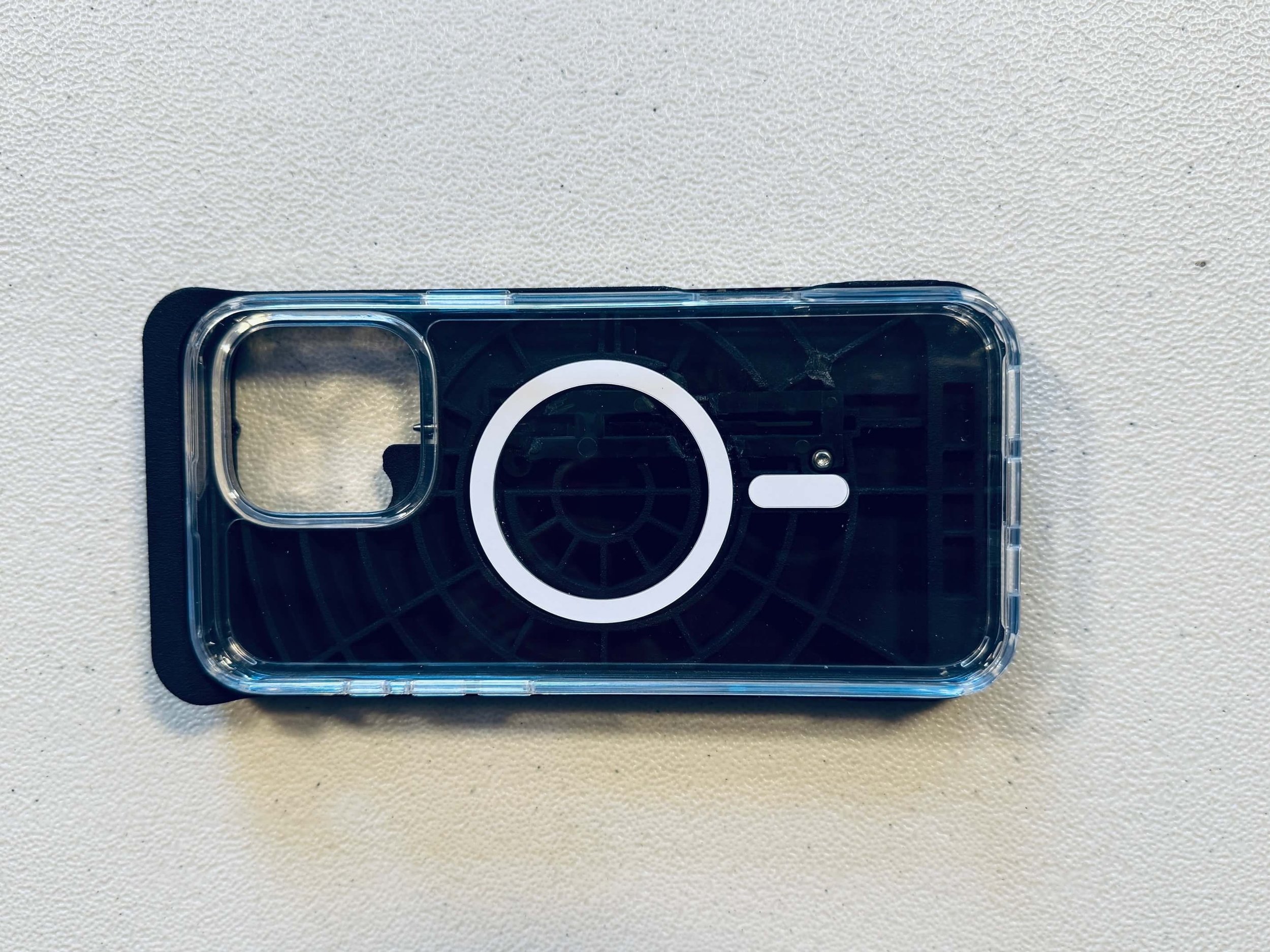 The Case for Vision MagSafe with a clear protective iPhone case resting on top of  it.