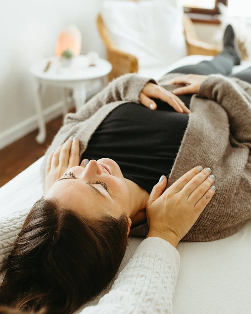 woman on massage table while receiving reiki energy healing