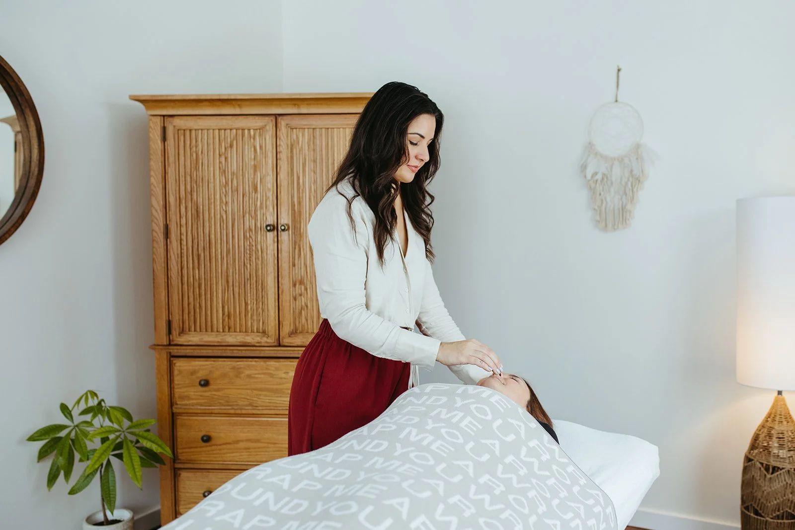 Stephanie Kamille giving Reiki to a client on a massage table