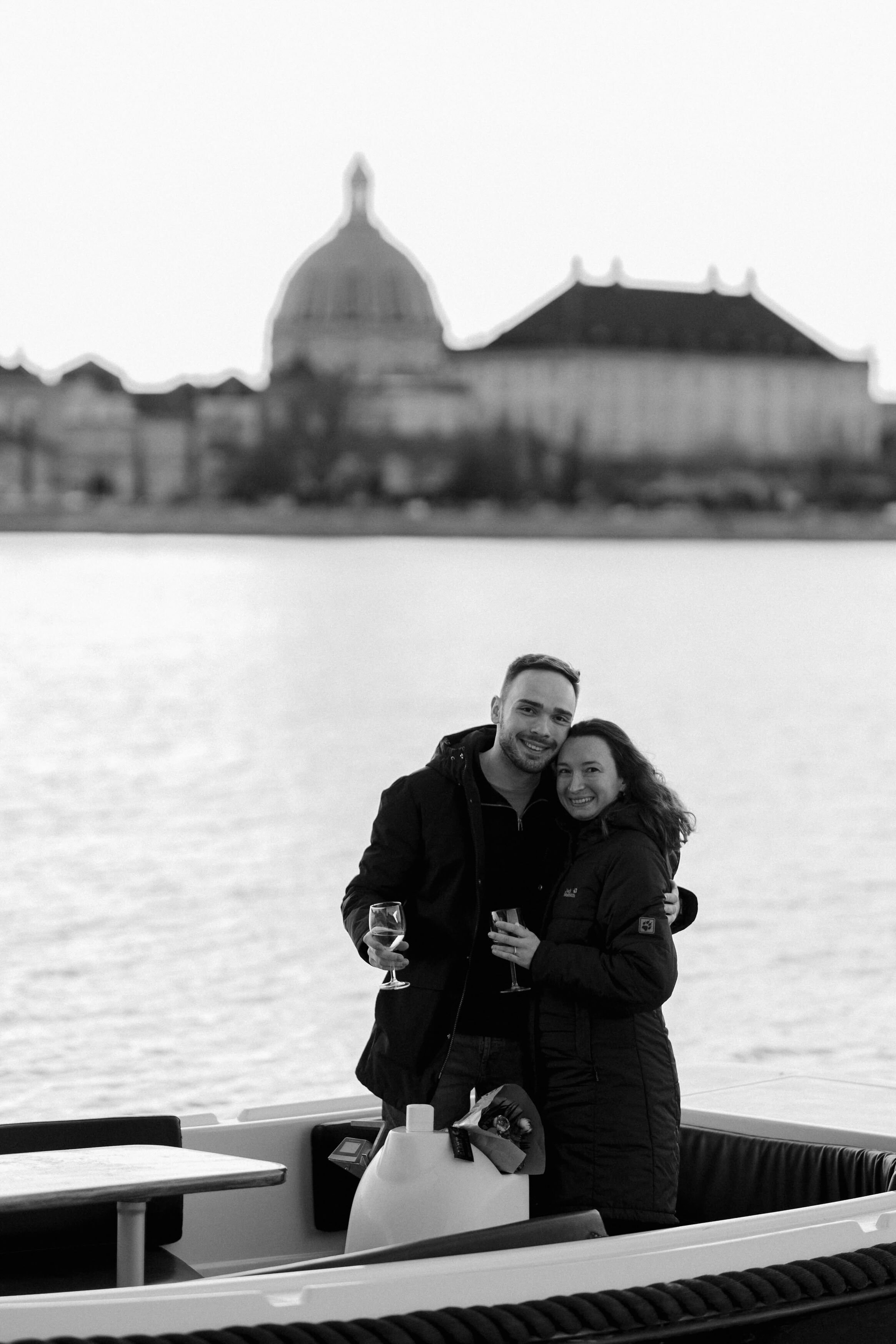 Secret Proposal on a Boat: the couple holding champagne glasses