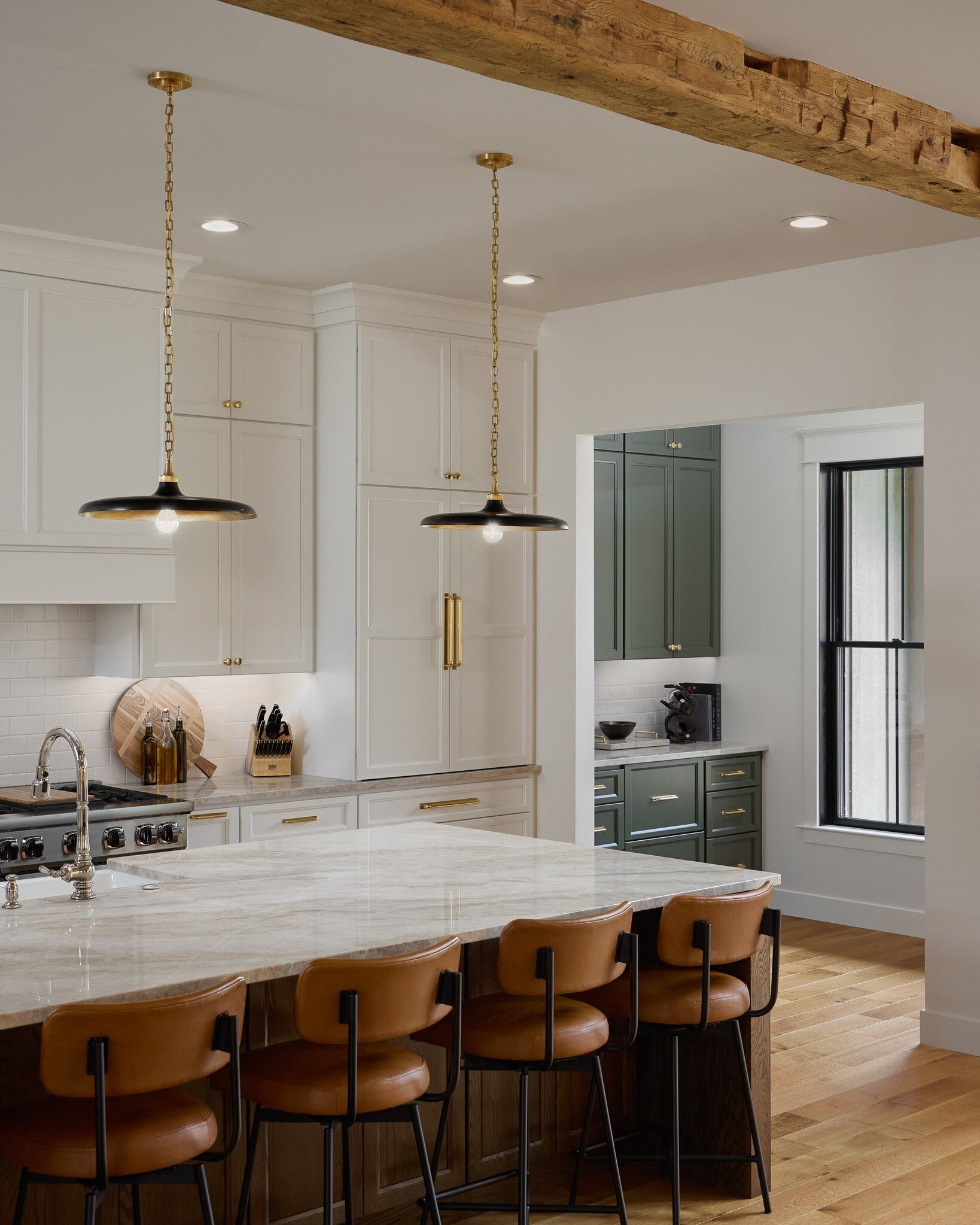 This couple fell in love with Taj Mahal during their visit, and it turned out to be the perfect complement to their green cabinetry and golden accents used throughout the kitchen. We are obsessed with the way this came together! 

Material: Taj Mahal