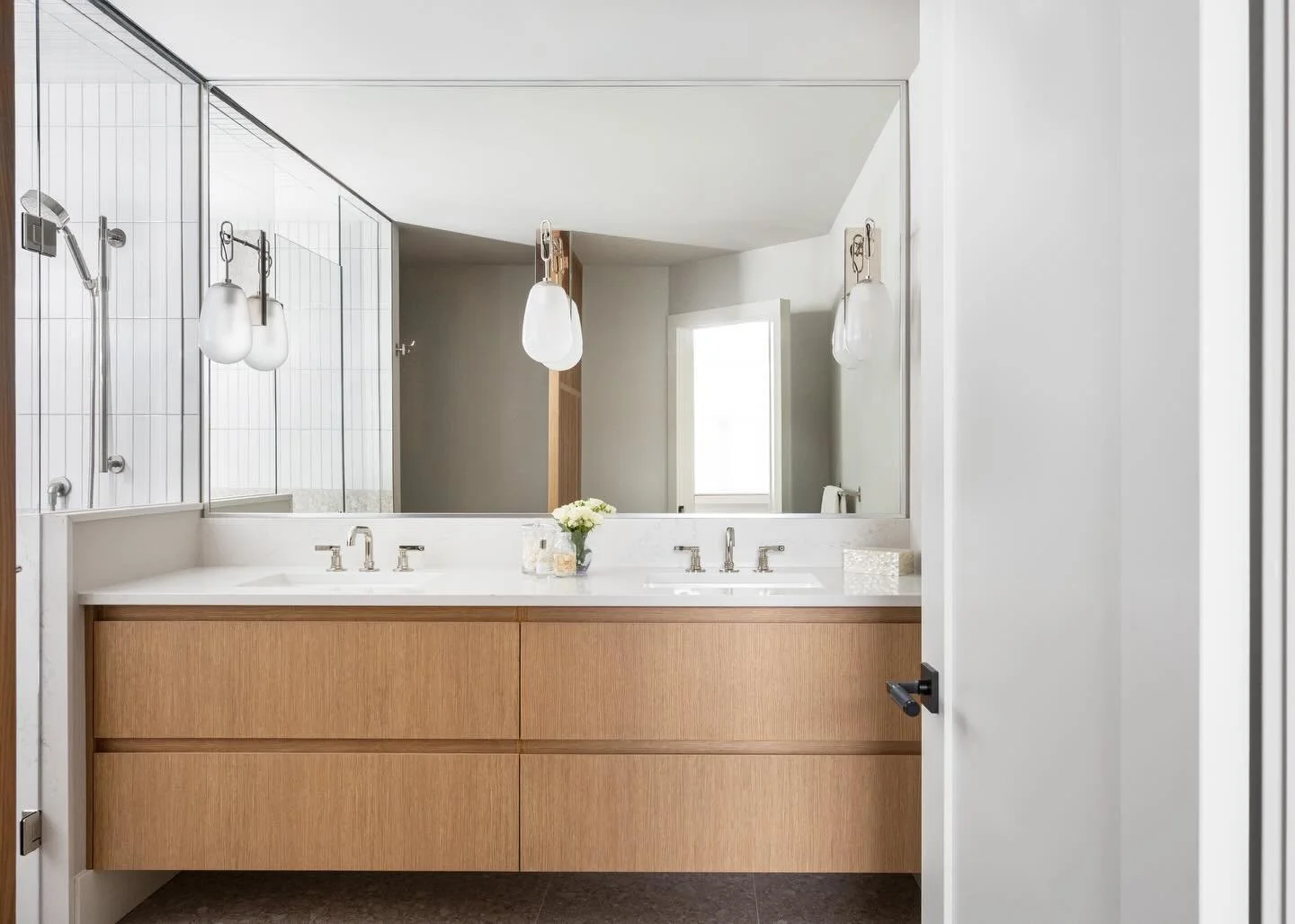 Location was everything when our clients bought this townhouse. The location of the plumbing in the ensuite? Not as ideal! 

With a door hitting the toilet every time it opened, to a tiny shower, to unused floor space and bad lighting, this space und