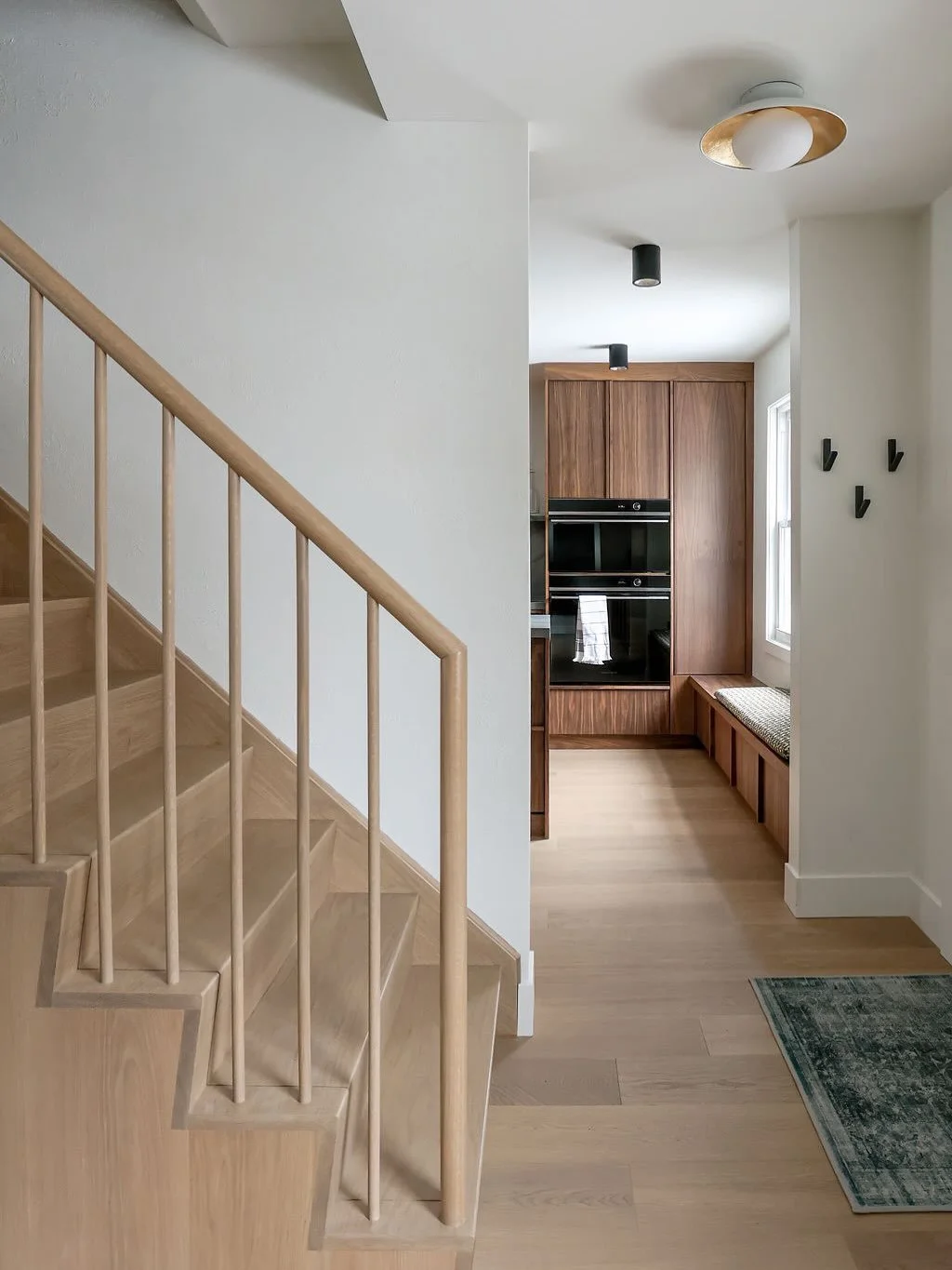 These stairs sure know how to make an entrance! 

Opening up the wall into the dining room brought additional light to the stairwell, the front entry and dining room. This minimal waterfall design really adds major impact to this home without being b