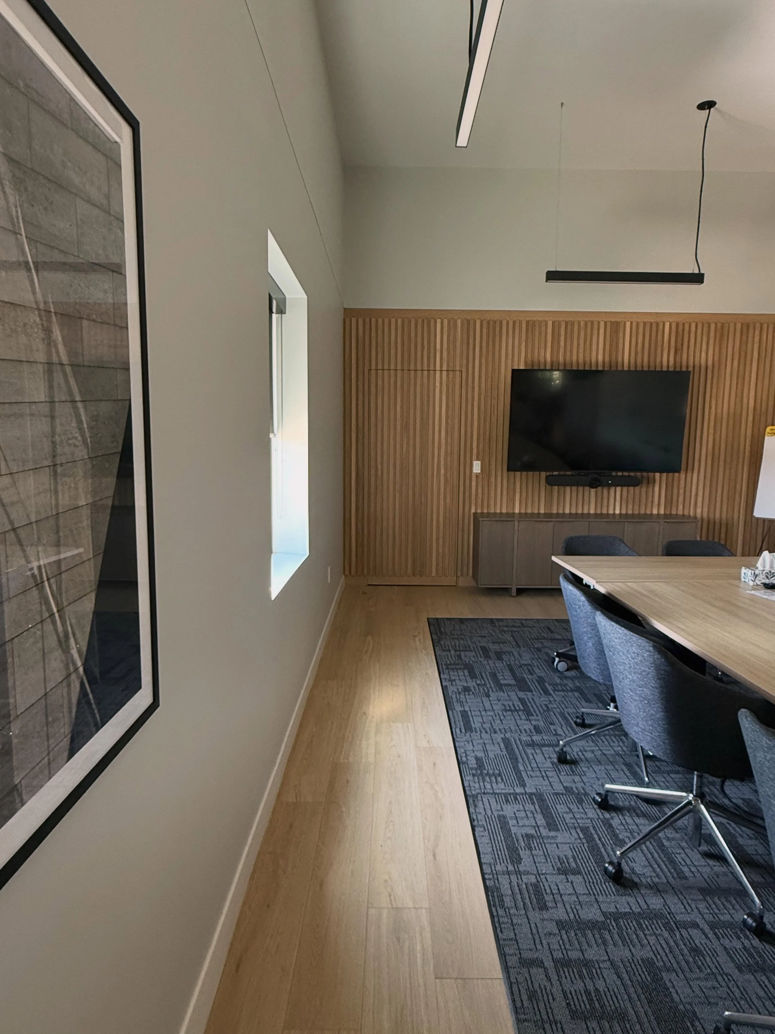 It&rsquo;s the big and little details that we pride ourselves on. 

Our commercial boardroom had a small utility room off of it that was great for storage but we didn&rsquo;t want it be a focal point in the room. Planning this continuous white oak sl