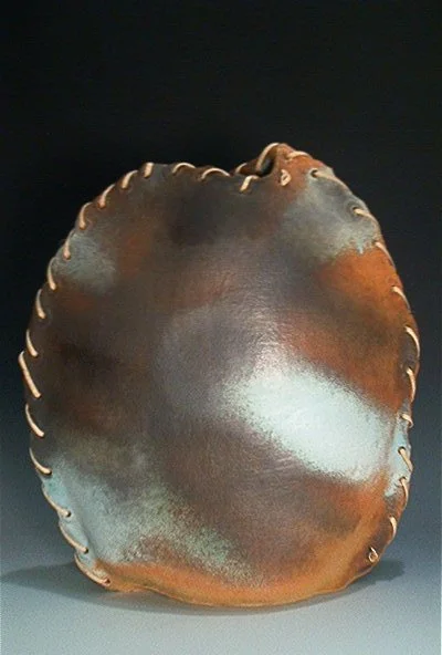 Hand-built stoneware vase with straw, fired in oxidation