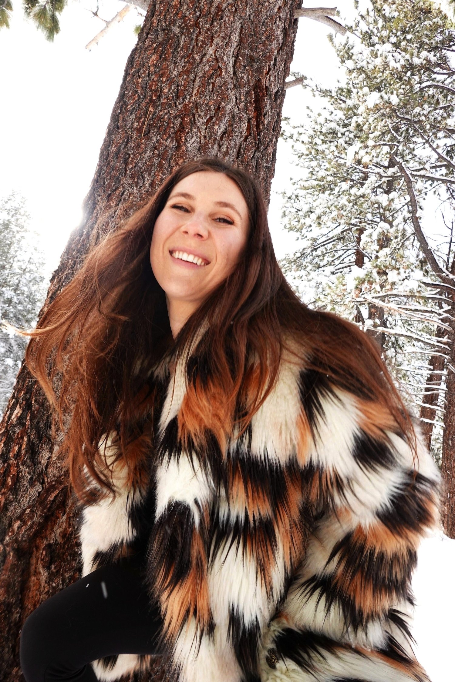 Emma Naomi Vaillant smiling beneath a blossoming tree