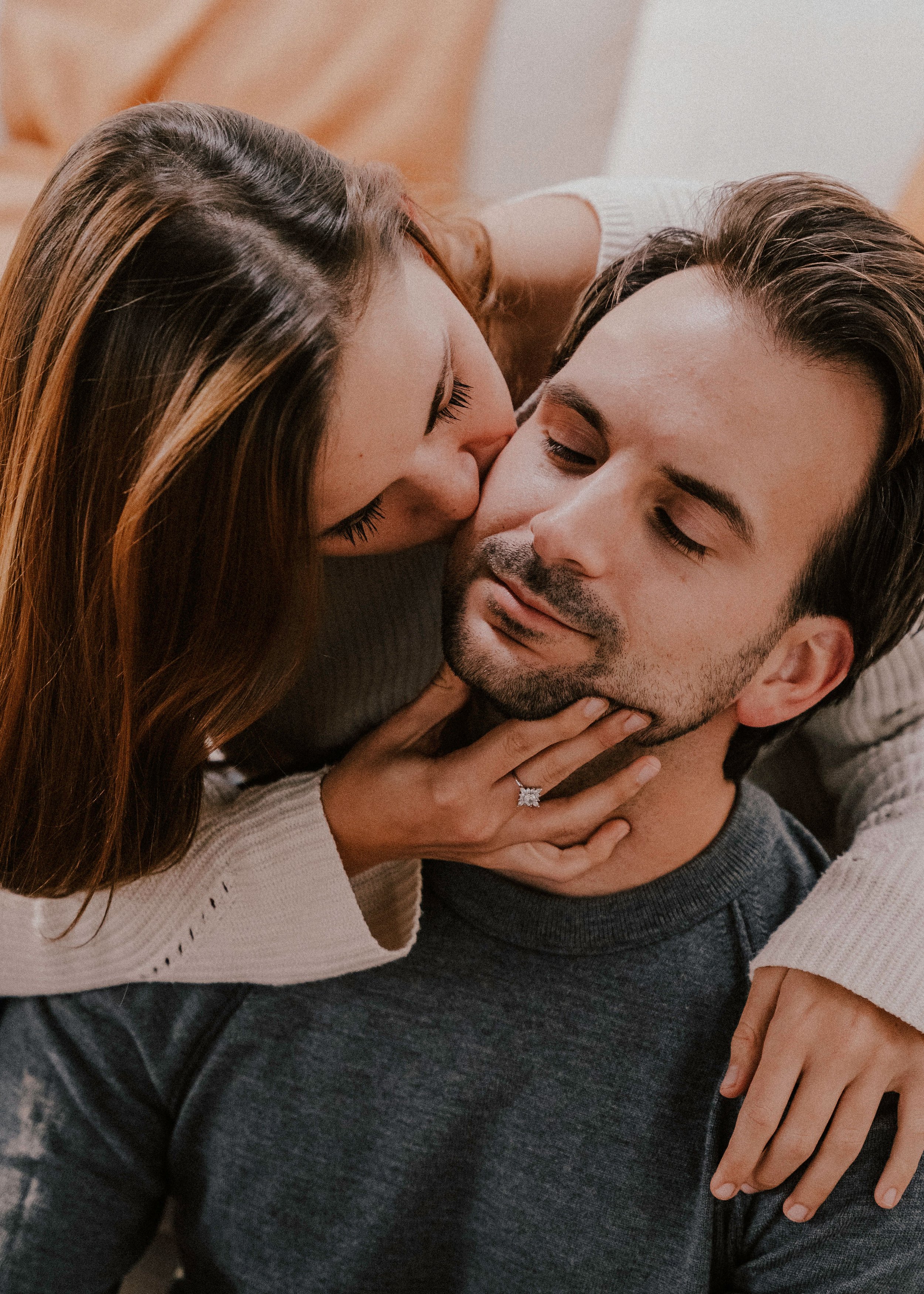 Joyful cute couple embraces. Young man in a sweater hugs a girl and kisses  her in winter. The concept of a successful relationship and happy moments  Stock Photo | Adobe Stock