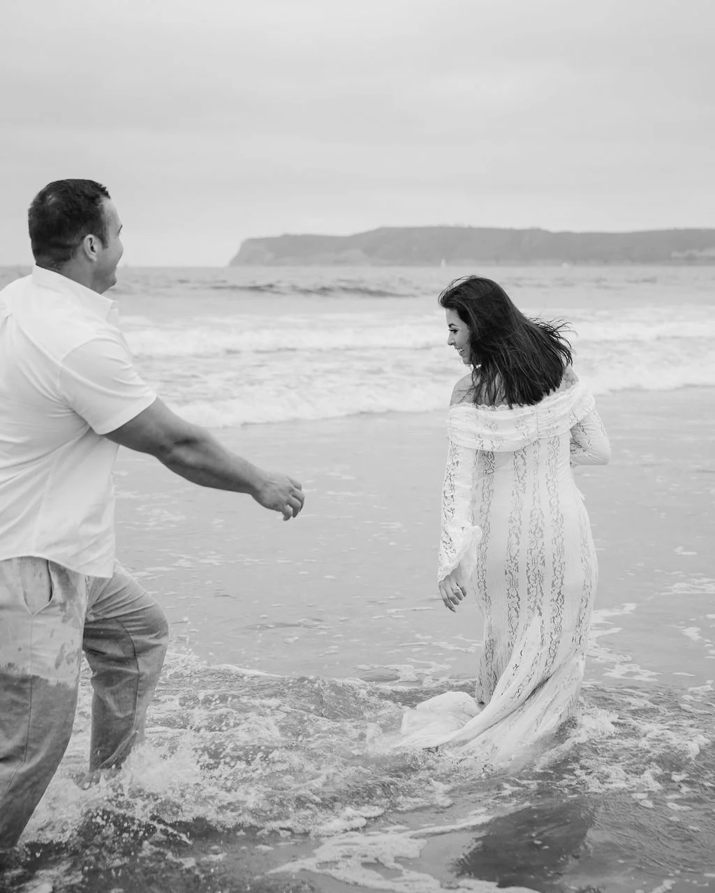 Candid beach couples portraits at Coronado Beach in San Diego during a sunset anniversary session.