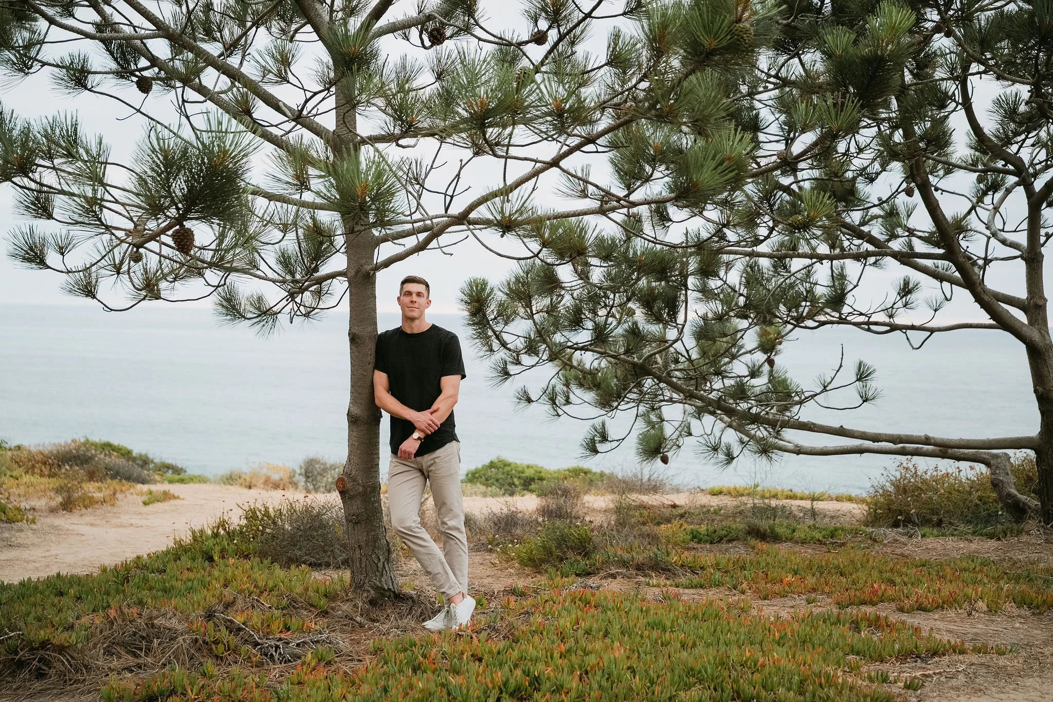 Professional outdoor portrait of a graduate student at Torrey Pines State Natural Reserve in San Diego.
