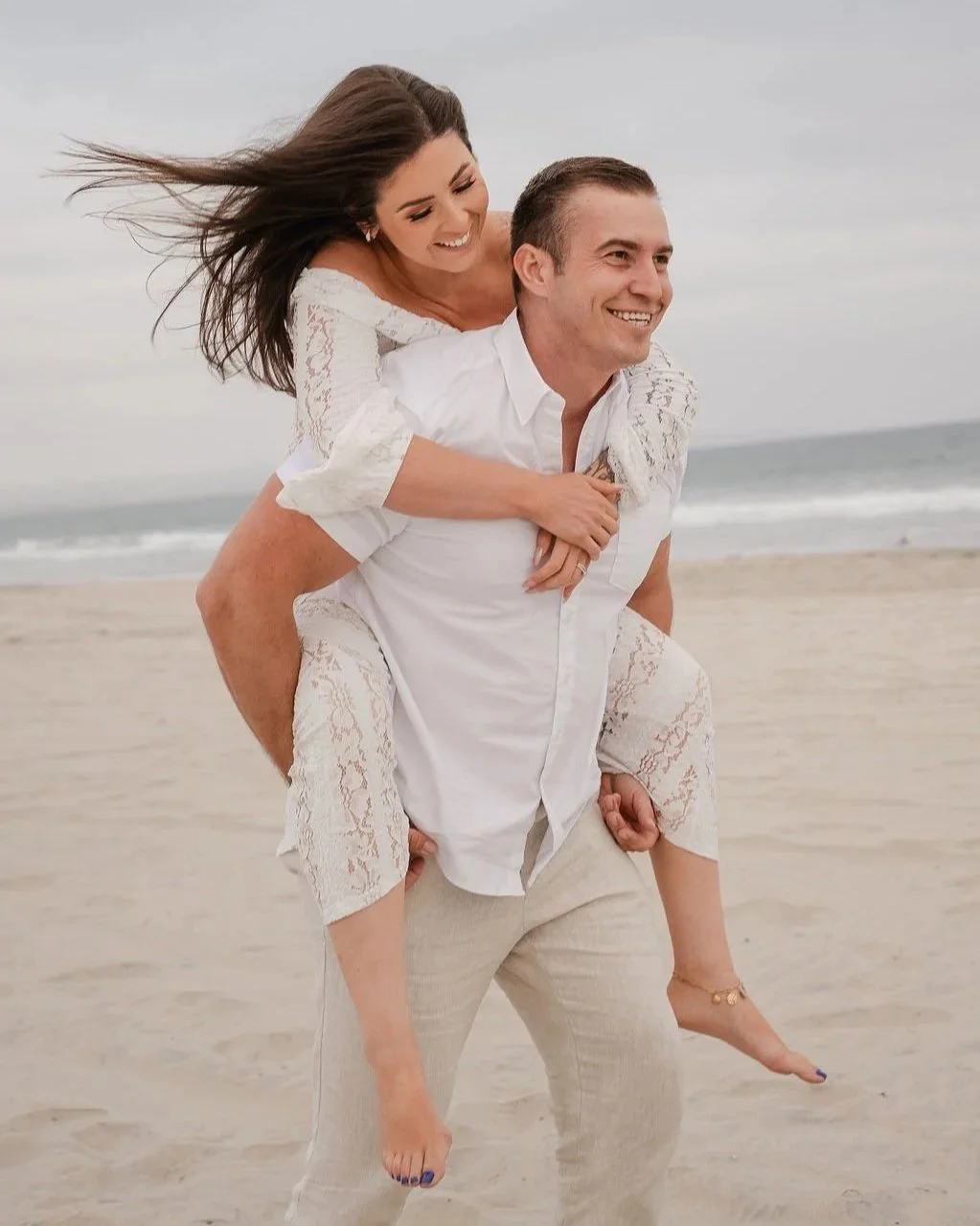 Couple celebrating their five-year anniversary with a sunset beach photo session at Coronado Beach in San Diego, California.