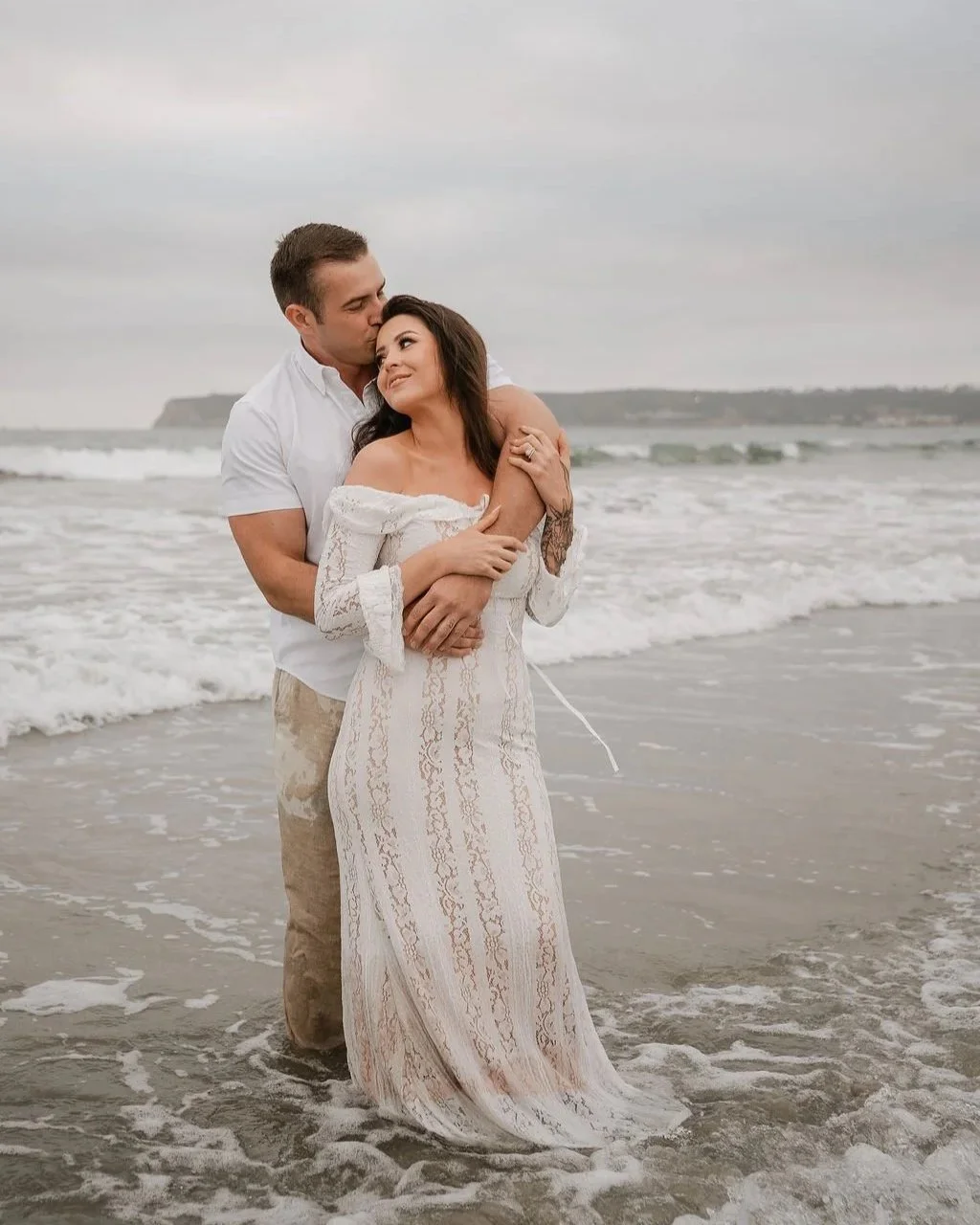 Couple celebrating their five-year anniversary with a sunset beach photo session at Coronado Beach in San Diego, California.
