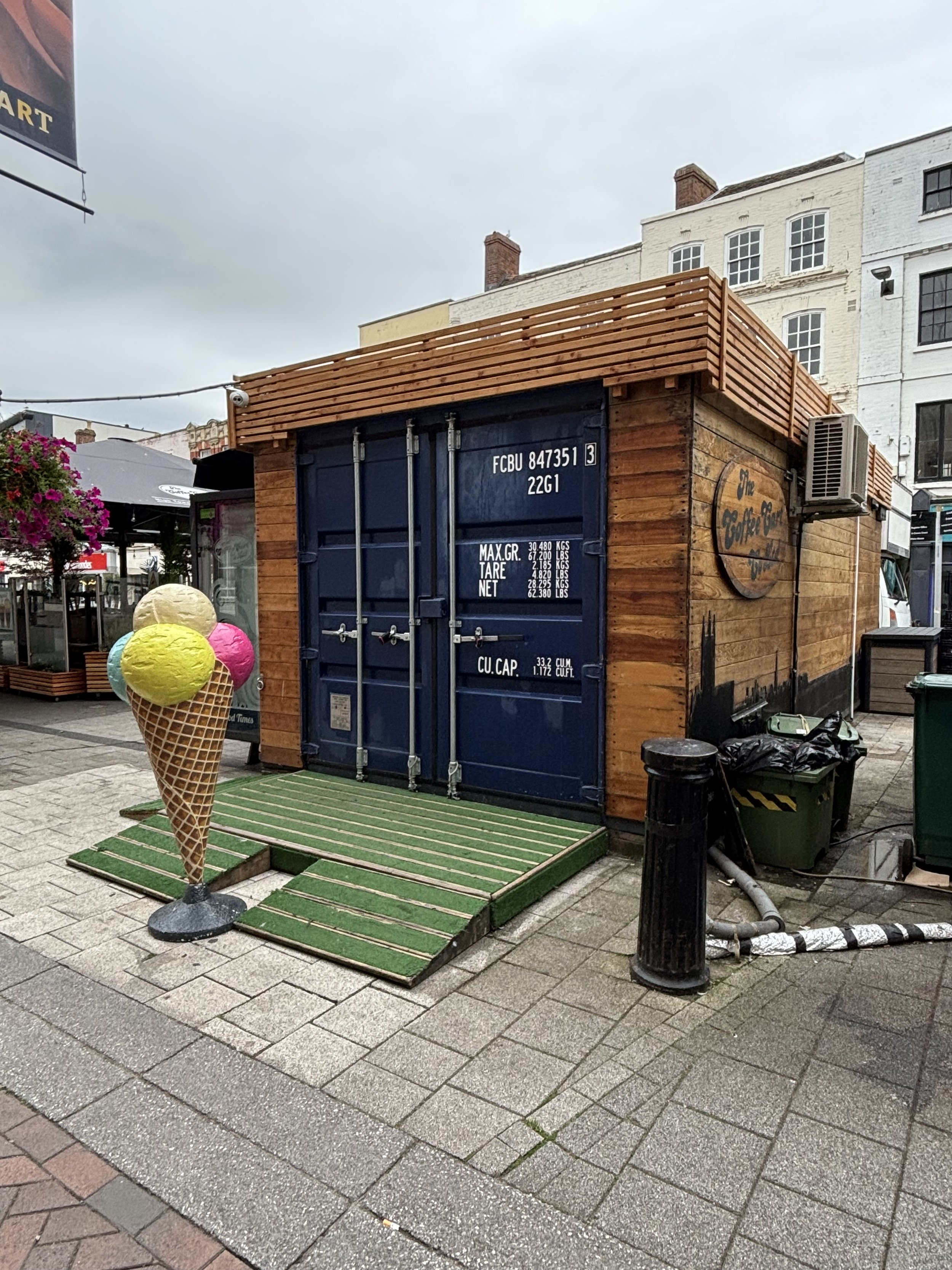 AN INNOCENT LOOKING OUTSIDE 'POP-UP' CAFE UNTIL YOU DIG DEEPER. NOTICE THE THINK ELECTRIC CABLE RUNNING TO THE TOP LEFT. ALSO ON THE FLOOR ON THE RIGHT THERE ARE HEAVY DUTY THINK CABLES ON THE FLOOR AND FEEDING INTO THE STRUCTURE