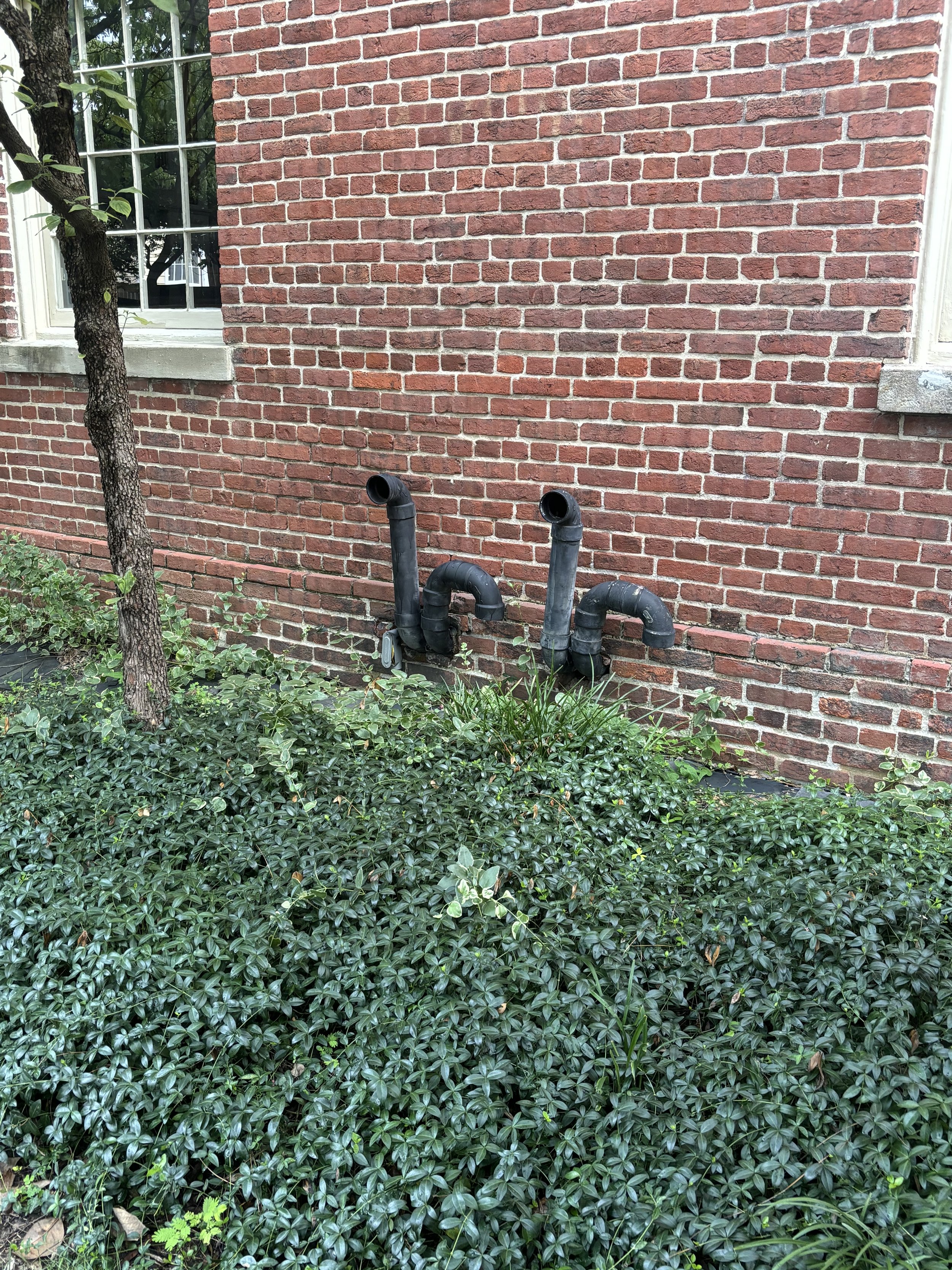 NEXT TO ST MARYS BASILICA CHURCH: TWO LARGE OUTPUT PIPES FOR LIQUID WASTE AND/OR WATER CONDENSATION ON THE WALL