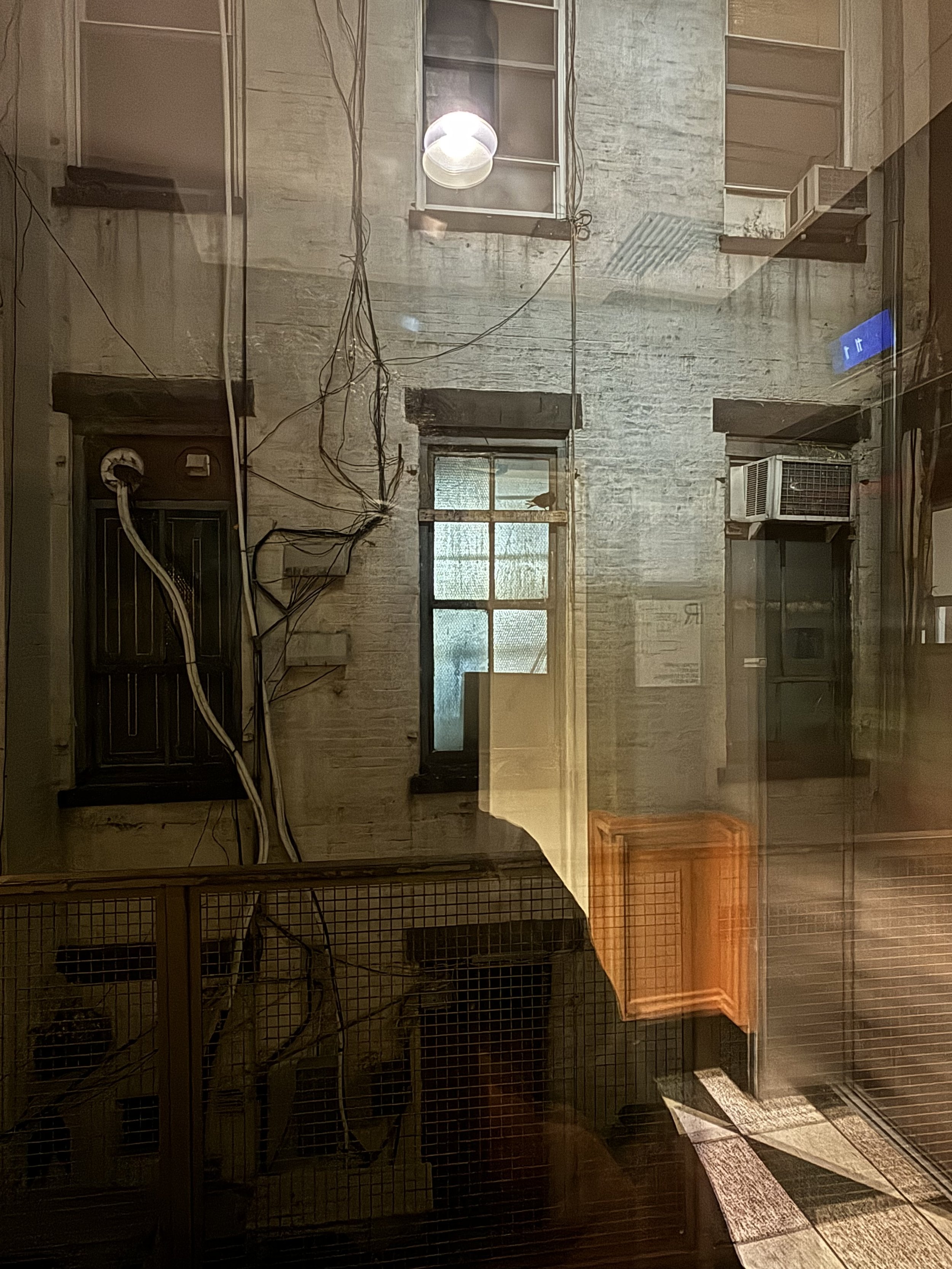 A LARGE AND UNTIDY CONFIGURATION OF PIPES, CABLES, HEATER / COOLER AND MORE ON THE SIDE OF A DOWNTOWN HOTEL