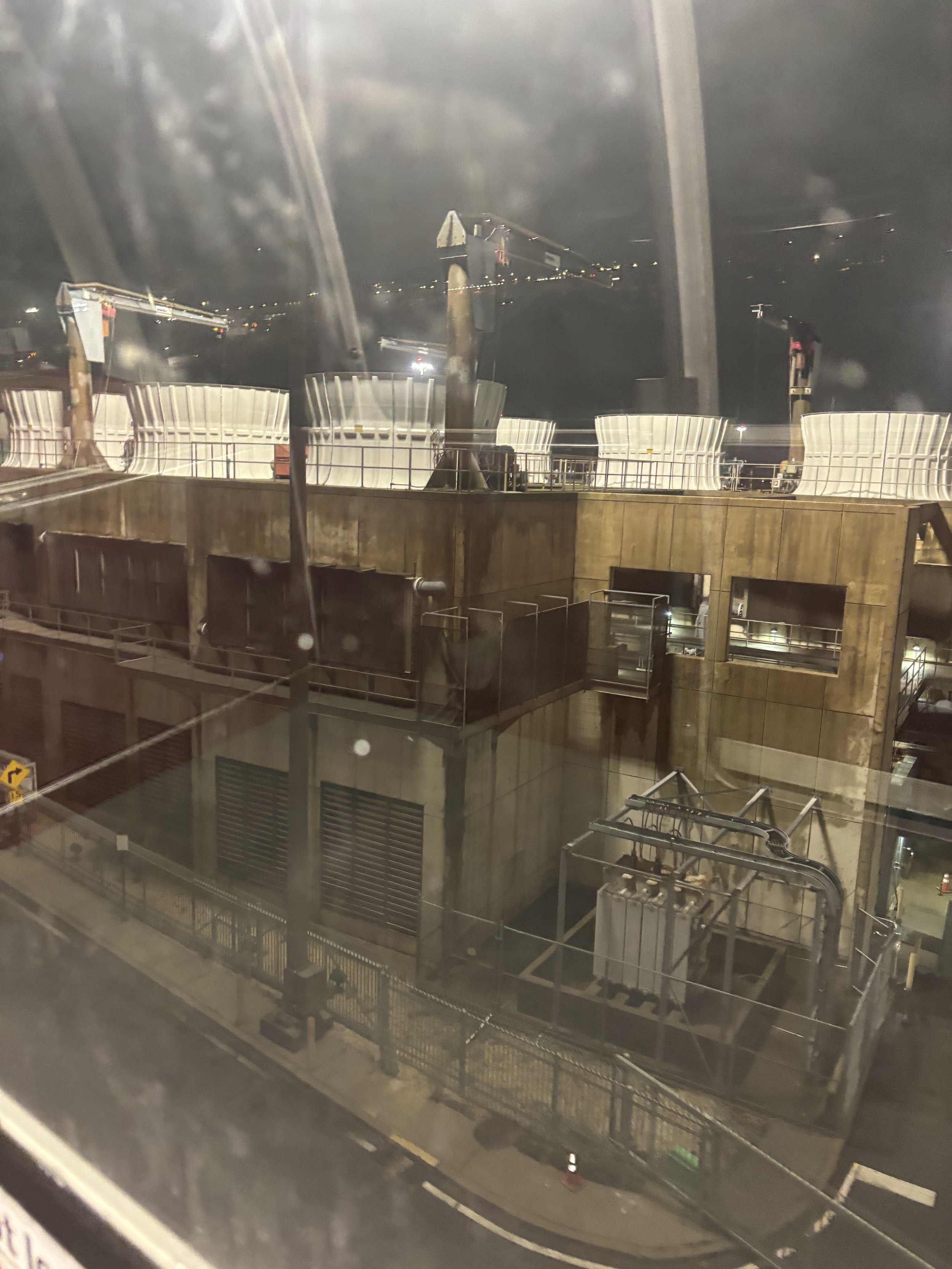 A LARGE ARRAYS OF LIQUID CONTAINERS (ON TOP), ELECTRICITY, ROCKER ARMS FOR LIFTING AND SIGNS OF A PROFESSIONAL FACILITY
