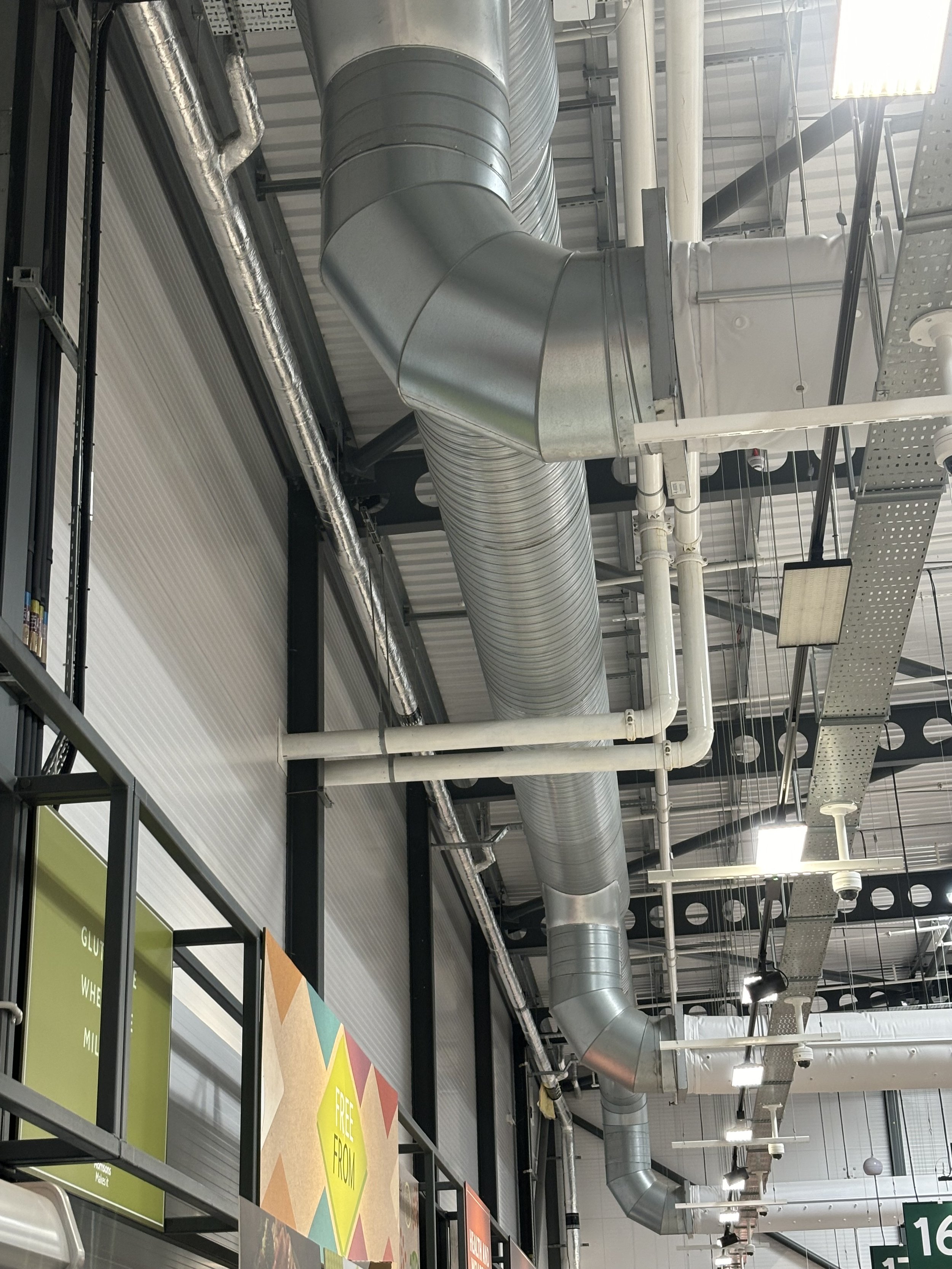 A MASSIVE ARRAY OF PIPES RUNNING IN THE ROOF OF THE ENTIRE STORE. WHY SO MANY PIPES?