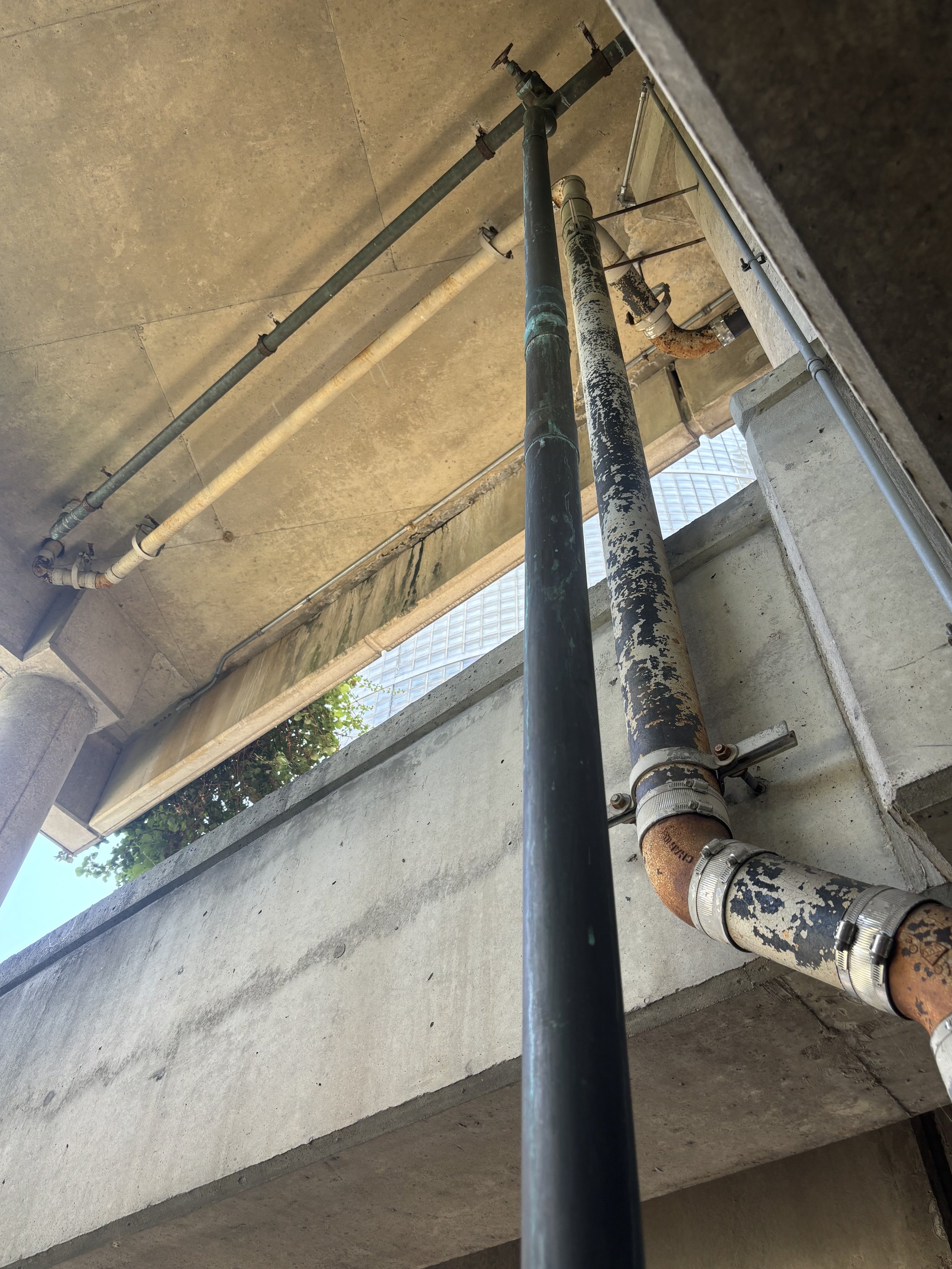 MORE PIPES VERTICALLY POSITIONED INSIDE THE CAR PARK (NOT SPRINKLERS)