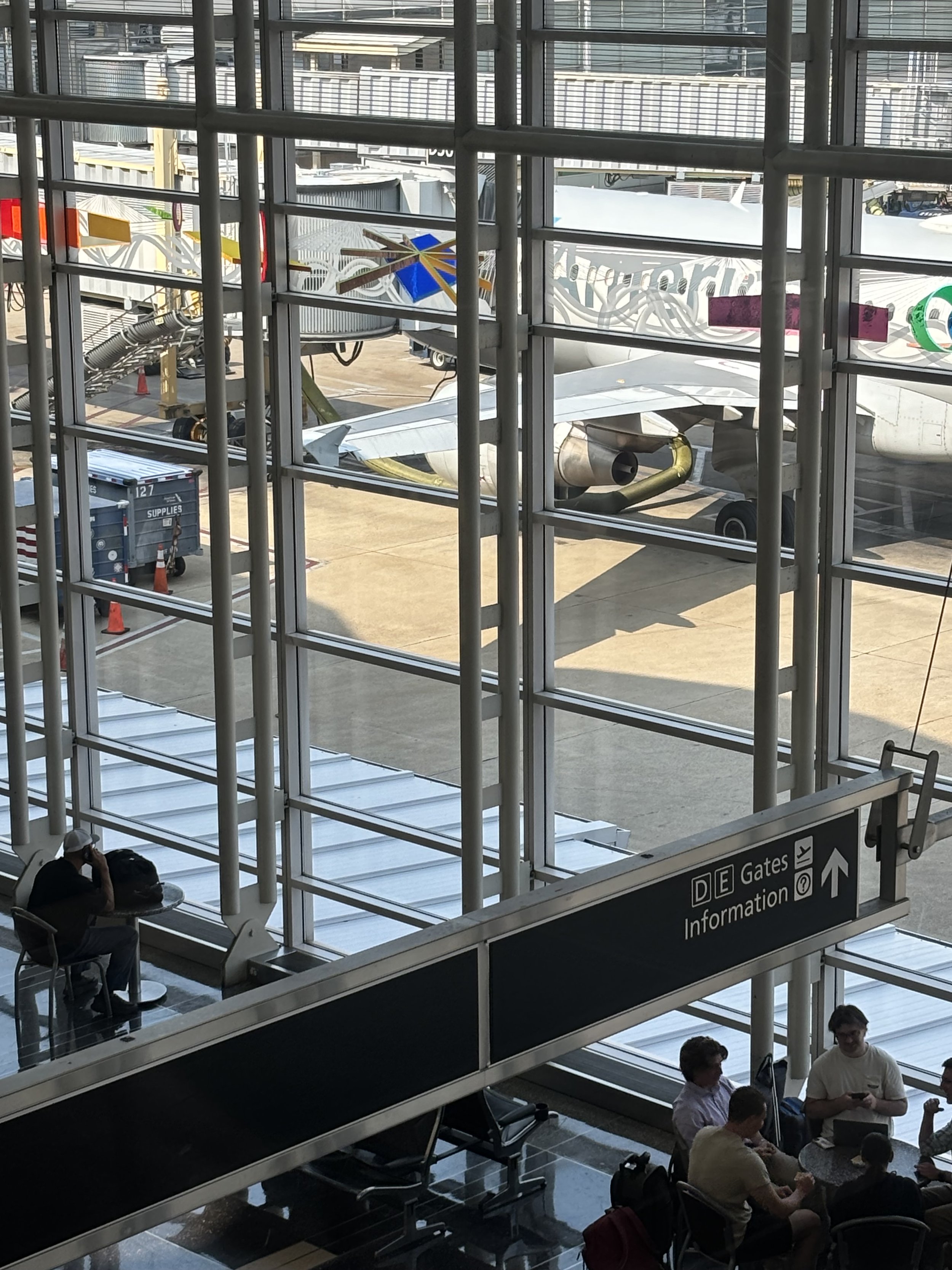 PAY ATTENTION TO THE GREEN PIPE RUNNING FROM A CONE STRUCTURE INTO WHAT SEEMS TO BE A WING OF THE PLANE. IS AQUAMATION LIQUID BEING PUMPED INTO A WING TO THEN DUMP OVER THE LAND OR SEA UPON ASCENT?