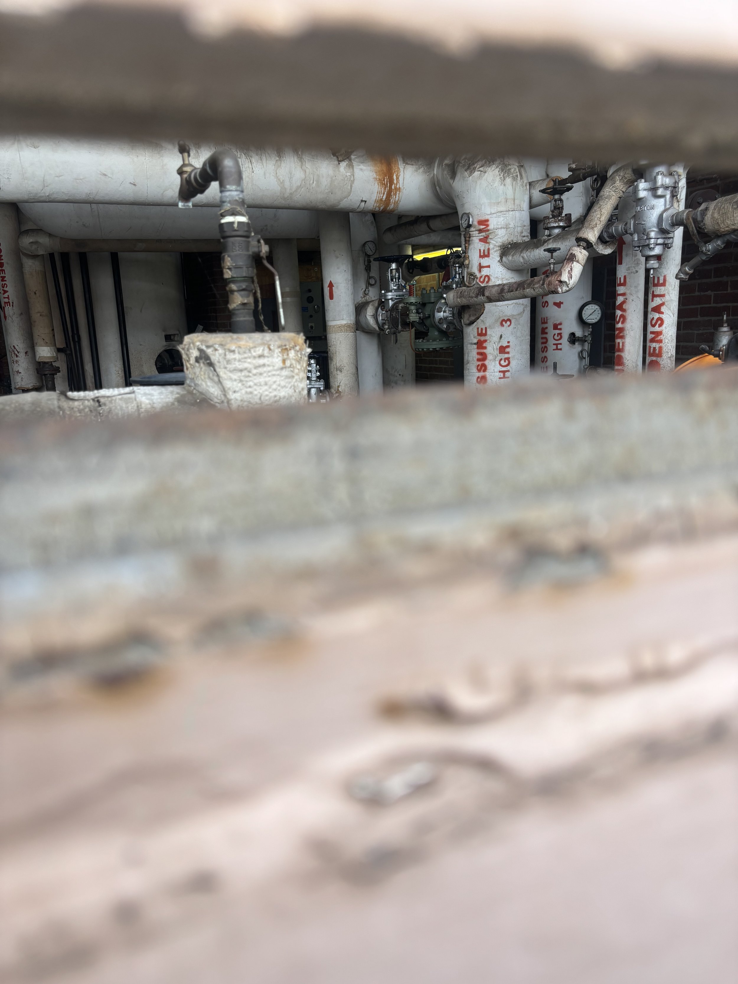 A CLOSE-UP INSIDE AN OPEN WINDOW WHICH ONCE AGAIN SHOWS AN ARRAY OR DIFFERENT SIZED TUBES. THESE LOOK QUITE OLD