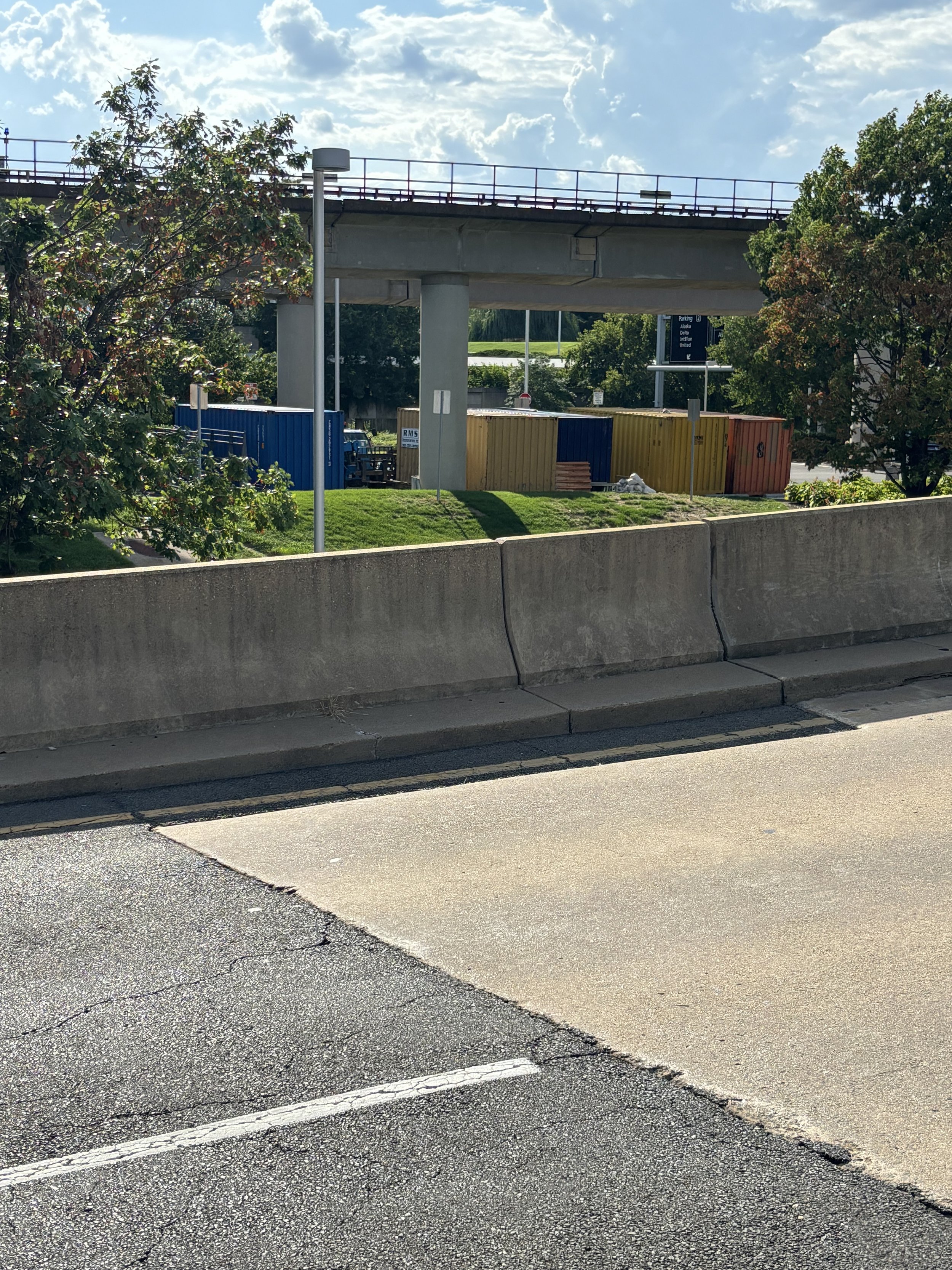 MANY CONTAINERS OPPOSITE THE CAR PARK WHICH ARE SEEN ALL OVER THE WORLD