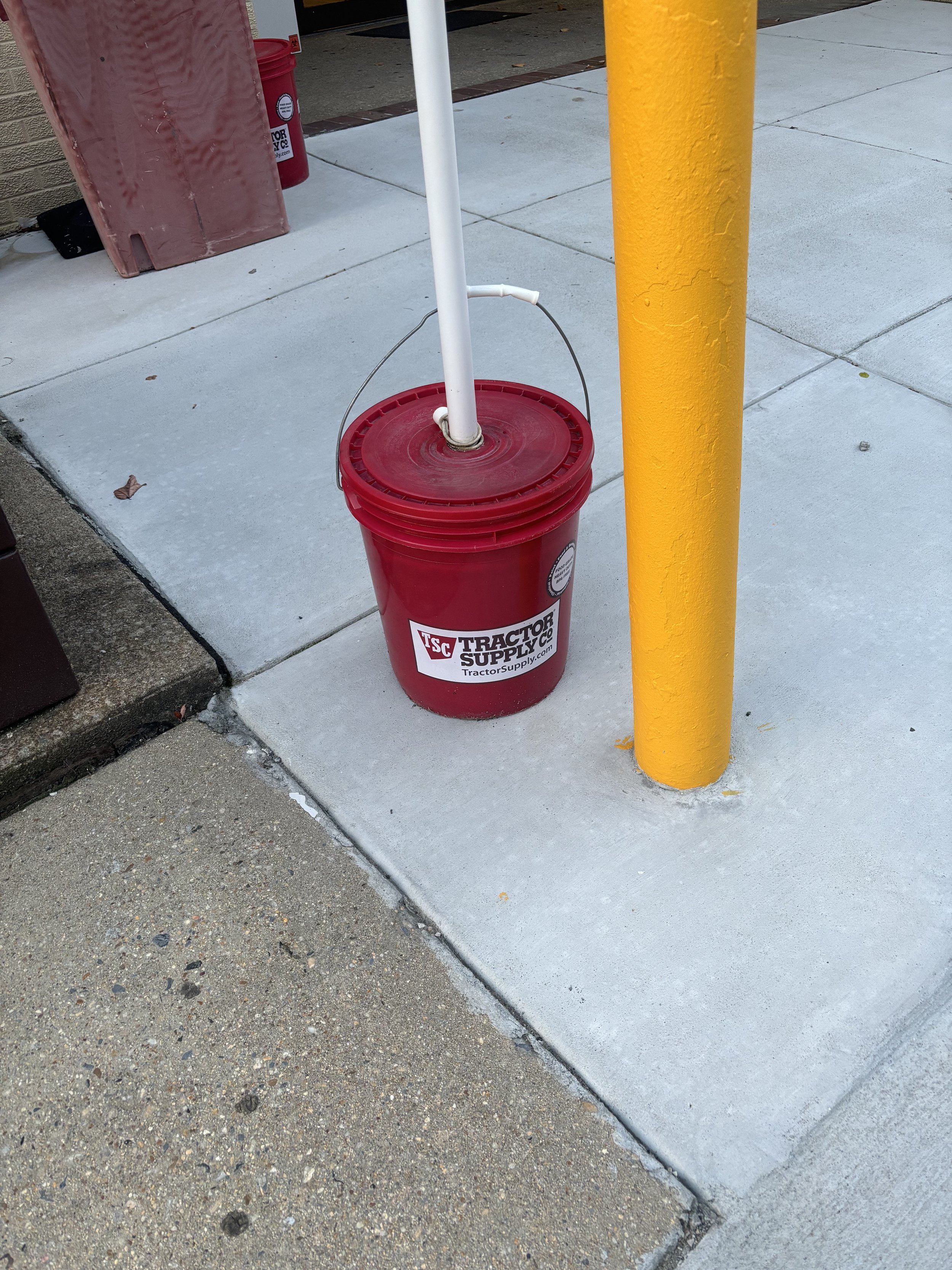 A BUCKET OF A CHEMICAL. THE AQUAMATION PROCESS NEEDS SODIUM HYDROXIDE WHICH CAN BE PURCHASED FROM 'TRACTOR SUPPLY LTD' (THE NAME ON THE BUCKET)