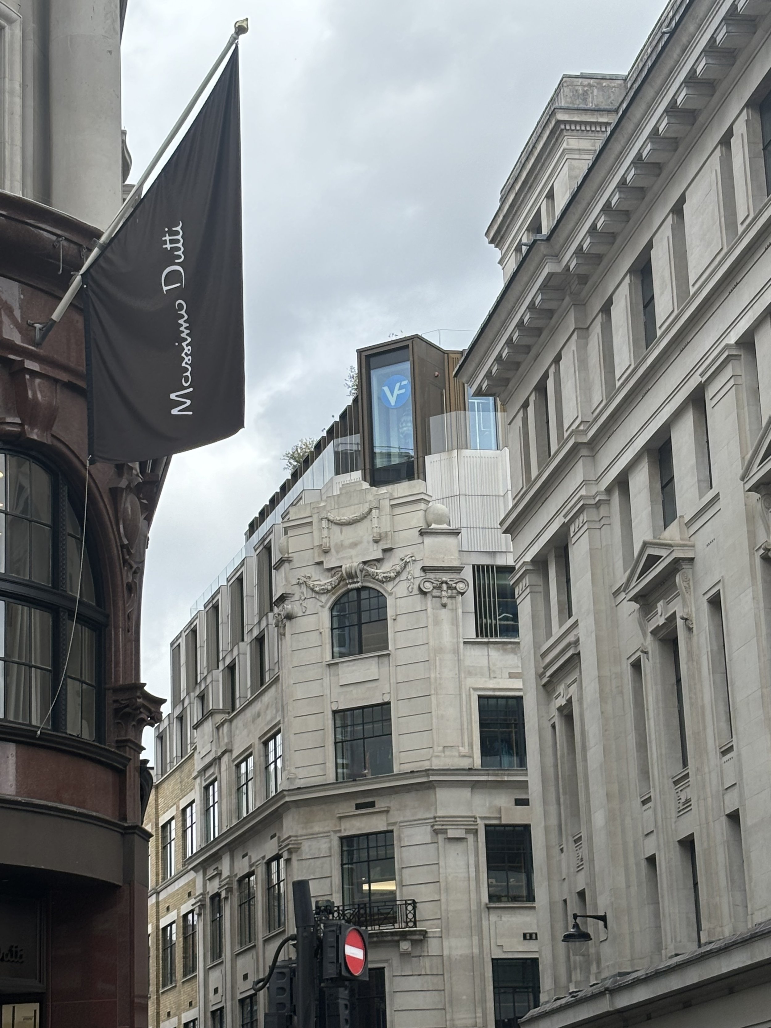REGENTS STREET. A HIGHLY SUSPICIOUS ARRAY OF SLATS AND A DOOR AT THE TOP OF A MORE ESTABLISHED BUILDING. NOT MUCH OF IT CAN BE SEEN EXCEPT THE DOOR AND HIGHLY SUSPICIOUS IT MIGHT BE AQUAMATION