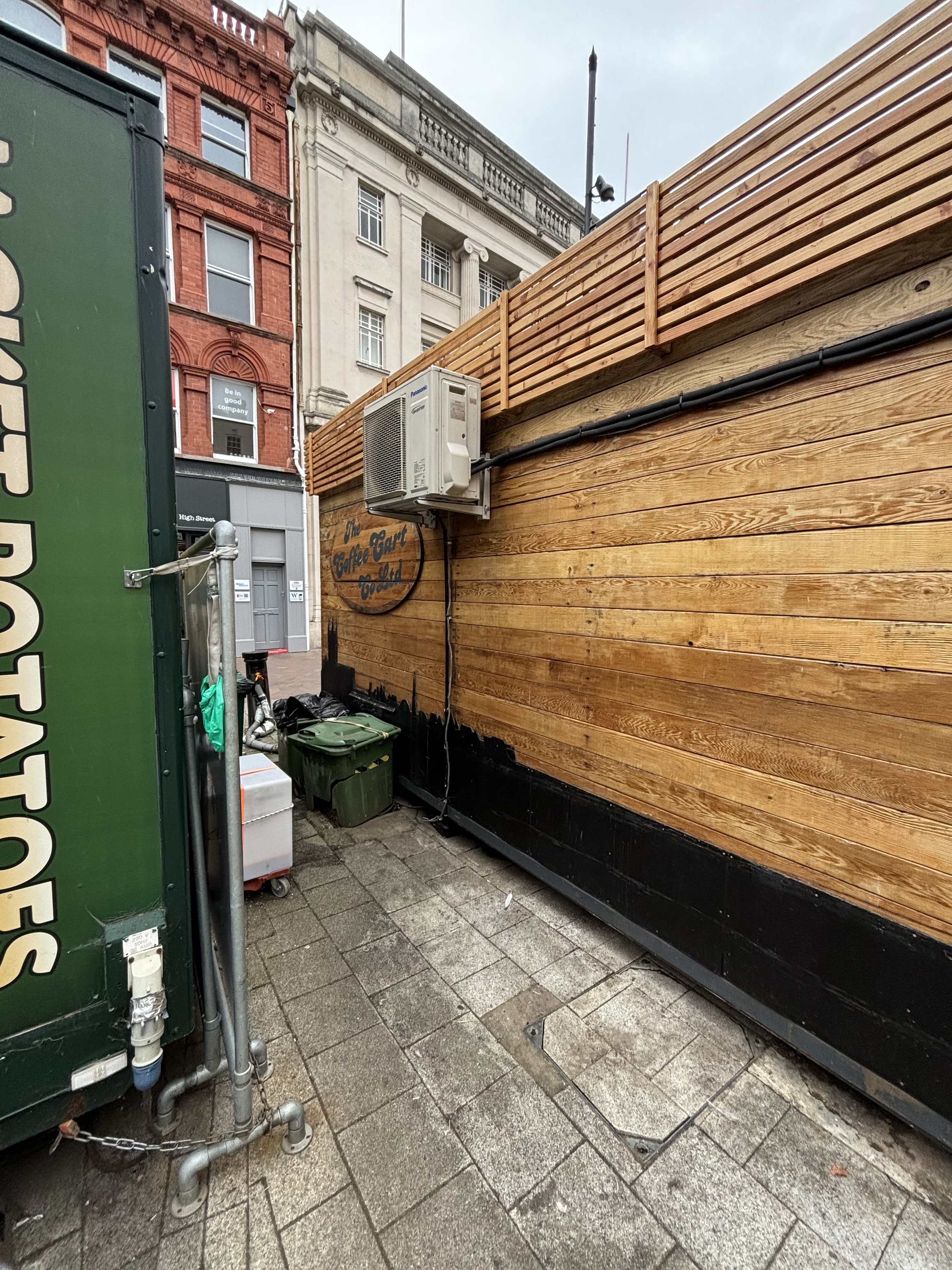 THIS VIEW FROM AROUND THE BACK SHOWS A HOT / COLD BLOWER BEING FED FROM WITH A THINK CABLE HORIZONALLY. OUT OF INTEREST - THE JACKET POTATO VAN (GREEN) TO THE LEFT HAS PIPES WHICH ARE FED DOWNWARDS INTO THE CONCRETE