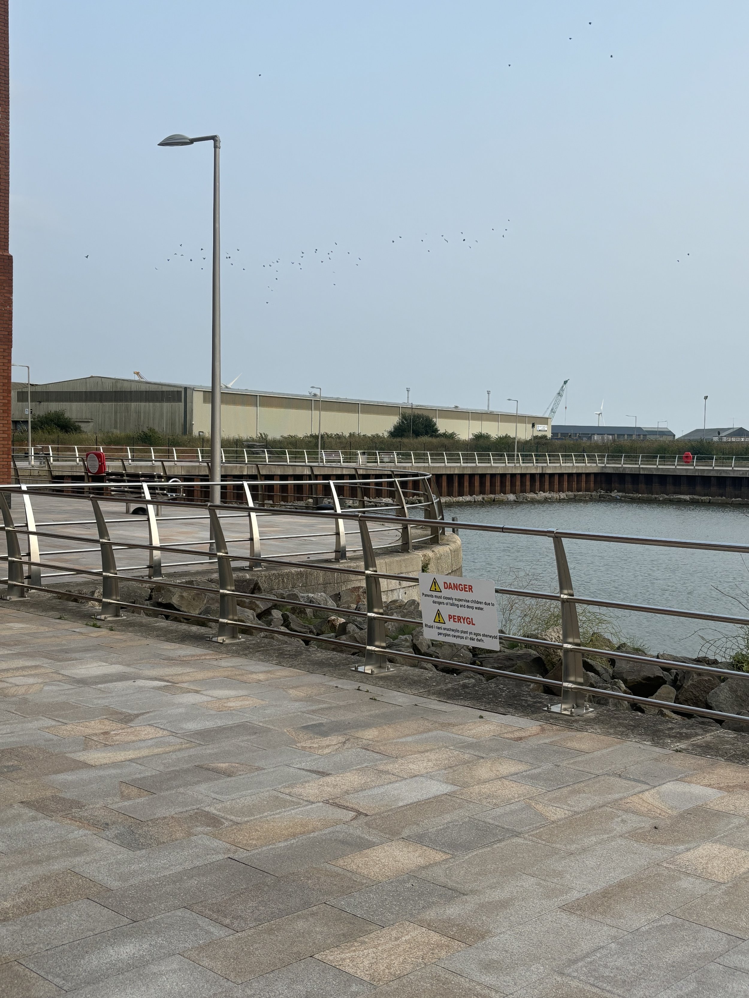 SWANSEA DOCKS. AN EXTREMELY LARGE BUILDING WITH CRANES NEARBY. YOU CAN ONLY VIEW TWO SIDES OF THE BUILDING FROM THE PUBLIC AREAS AND AN AQUAMATION FACILITY WOULD BE PERFECT RIGHT NEXT TO THE DOCKS FOR LOADING/UNLOADING CONSIGNMENTS