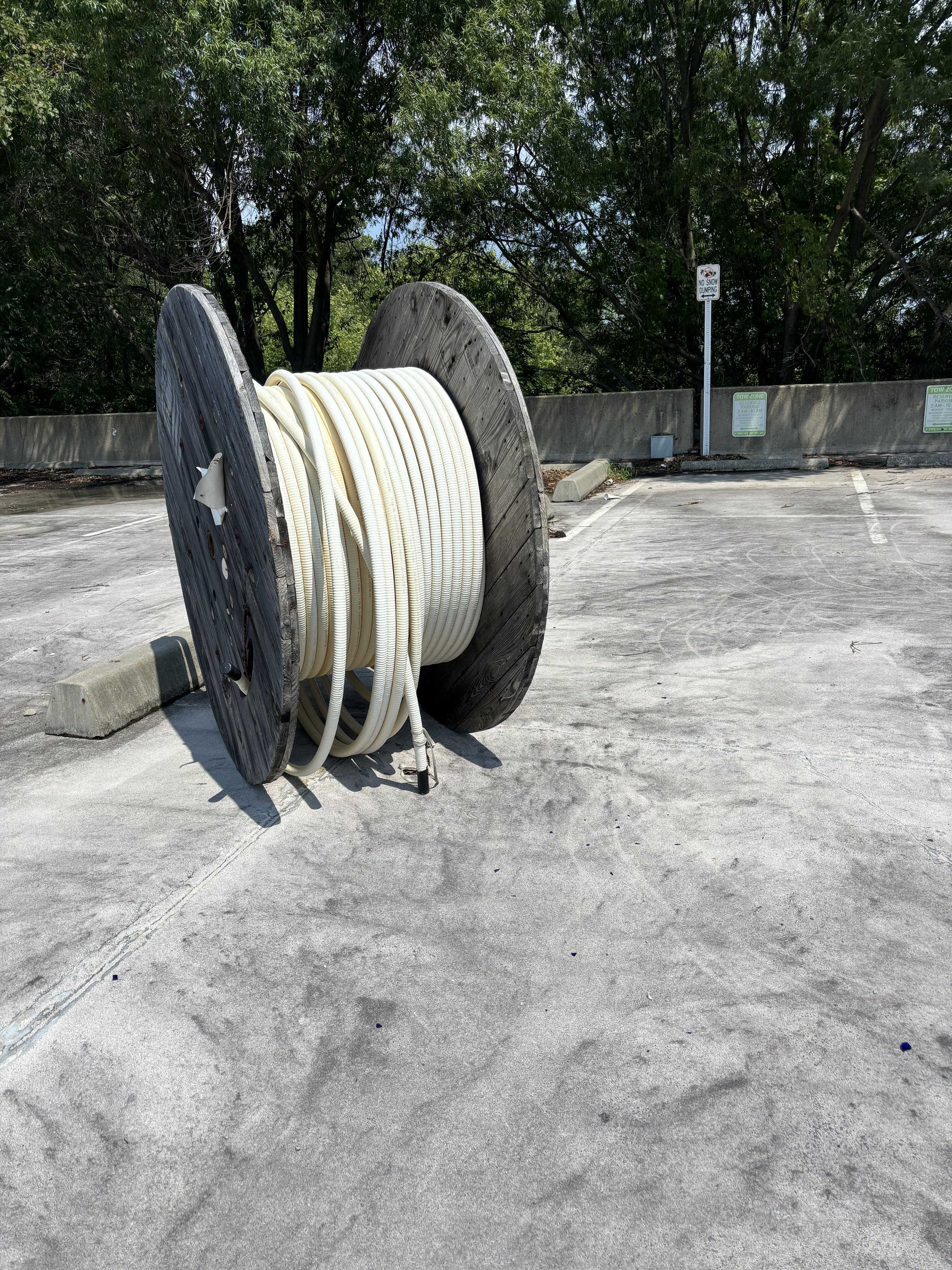 A ROLL OF PIPING ON TOP OF THE OLD CAR PARK ADJACENT TO THE METRO STATION